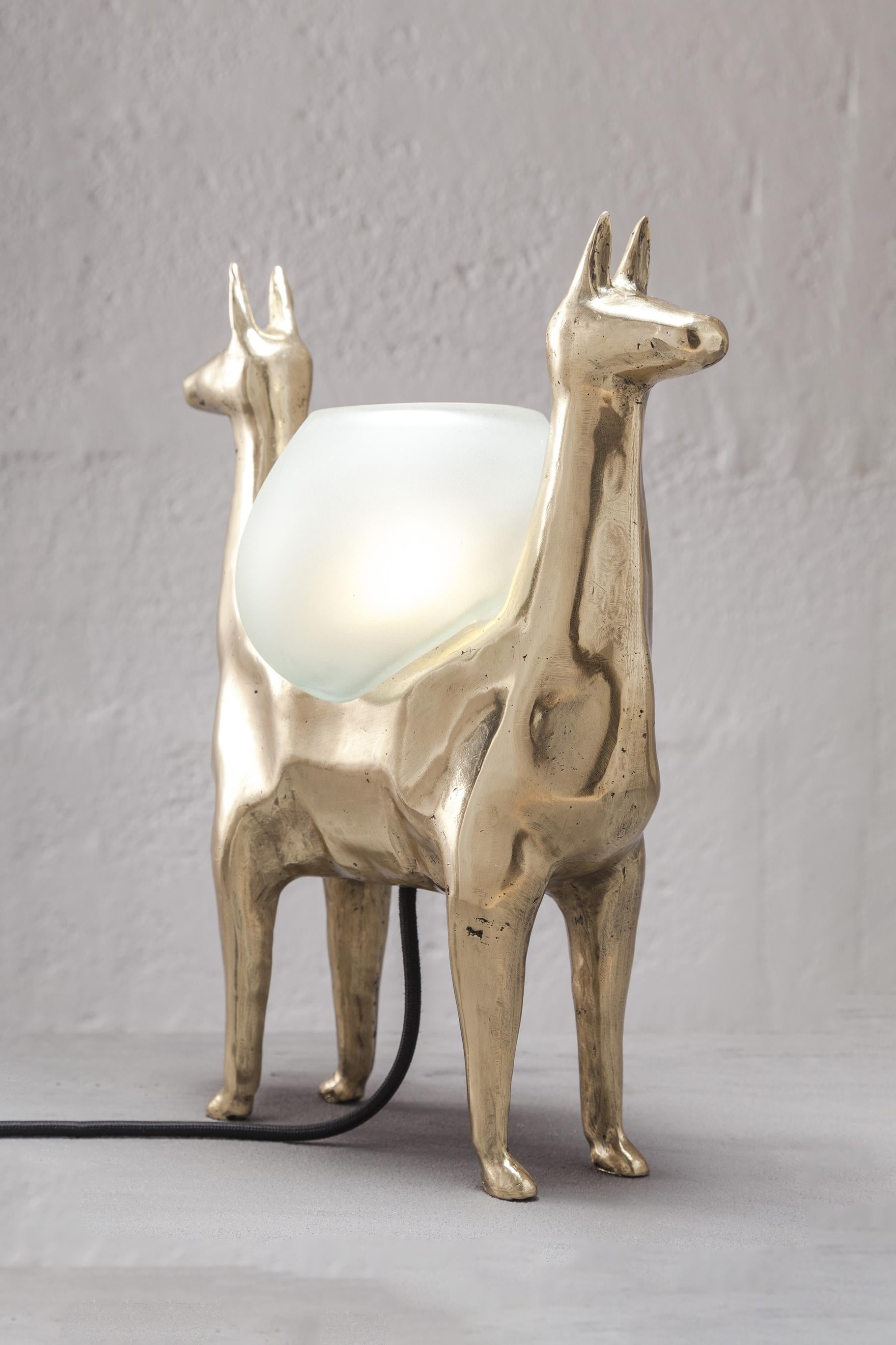 LLAMAS is a table lamp, composed of a lost-wax cast bronze body, and a handblown glass lampshade. It is a reinterpretation of an archetype of llama sculptures essential within Ecuadorian artisanship. The form was hand-sculpted in ceramic, then 3D