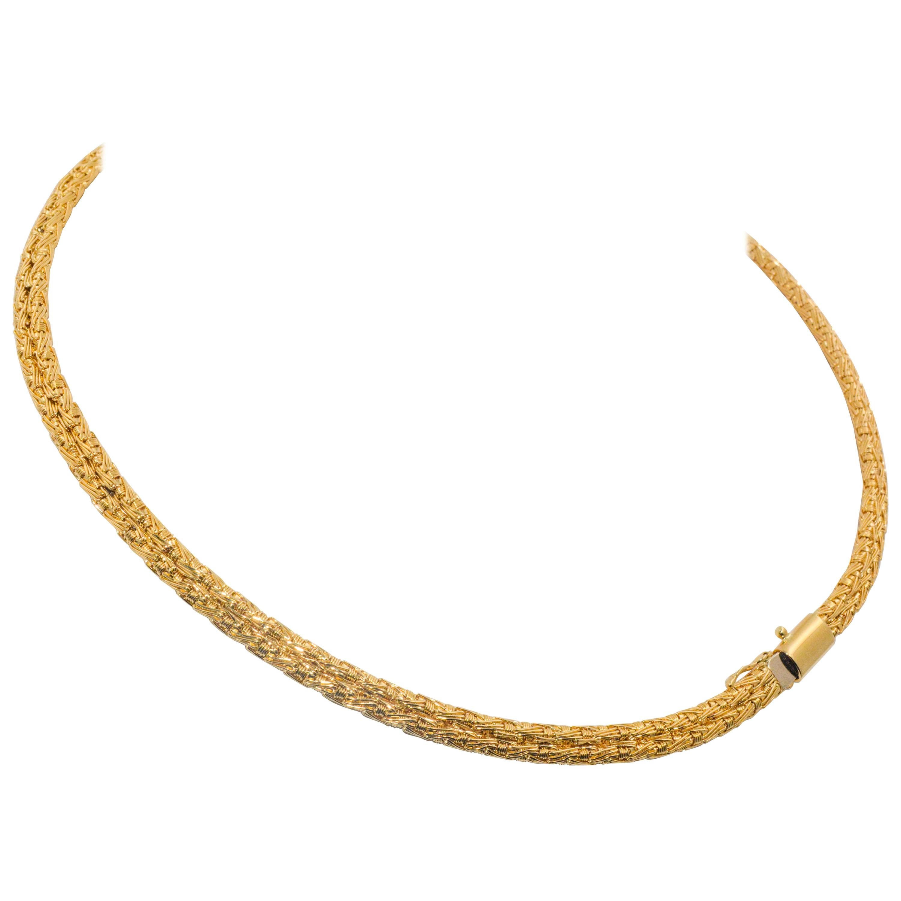 In a Greek Byzantine style, designer LLias Lalacounis weaves an incredible necklace collar. Lightweight and glamorous yet substantial enough to feel regal, this collar is stunning in 18 karat  yellow gold. 17 inches in length.