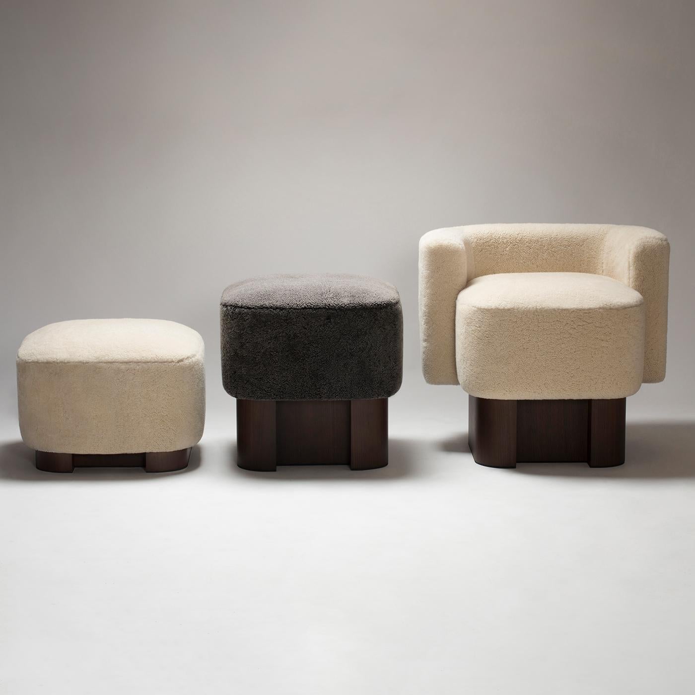 Lloyd is a collection where natural elements such as dark-stained Canaletto walnut wood and shearling play a calm symphony of craftsmanship, serenity, and aesthetics. Made of dark-stained Canaletto walnut wood & cashmere and wool or shearling.