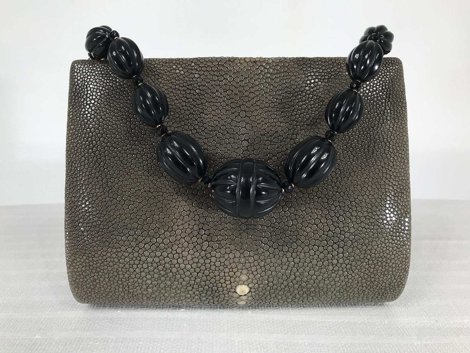 Lloyd Klein, Paris shagreen and rosewood evening bag with a carved stone beaded handle. Natural colour shagreen in greyish green, the beaded handle is black. The bag frame is rosewood and closes with a strong magnetic clasp. The bag sides are soft