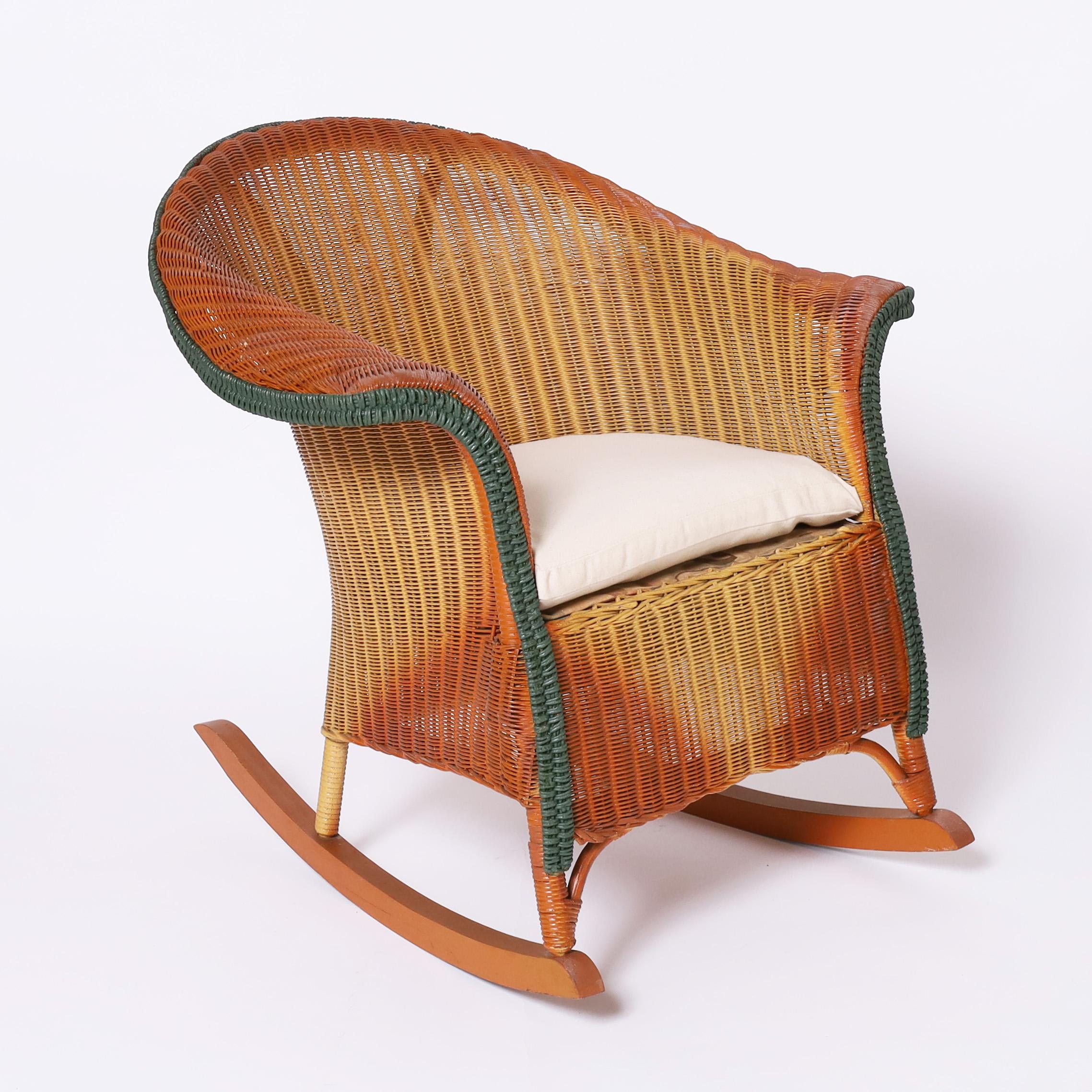 Rare and remarkable child's six piece suite of furniture crafted in wicker in art deco high style including a settee, rocking chair, armchair, table, lamp and planter all in the original three color finish and signed Lloyd Loom.

Rocking chair- H: