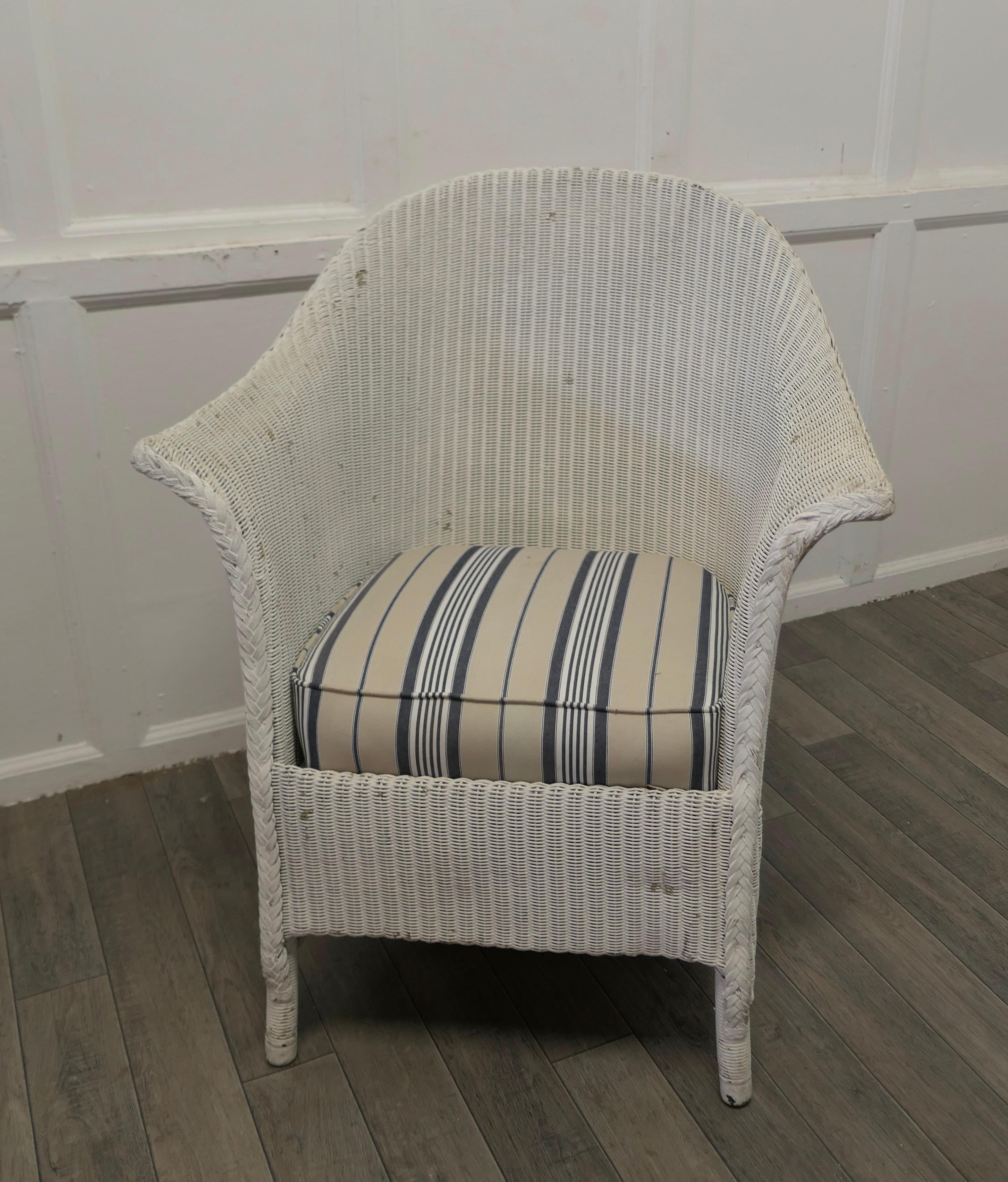 Lloyd Loom easy chair 

This delightful Shabby Lloyd Loom armchair dating from the early 20th century 
The chair is a generous sweeping shape and has a comfy sprung seat which has new upholstery in a seaside Linen Stripe 
The chair is sound, the