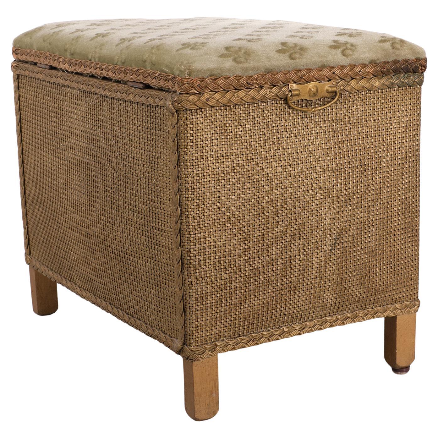 Very nice Loyd Loom storage box . Also very useful for a extra seating place .Original Green Wool upholstery  .France Lely decor .Two handles on the sides and on the front . Gold color base . 