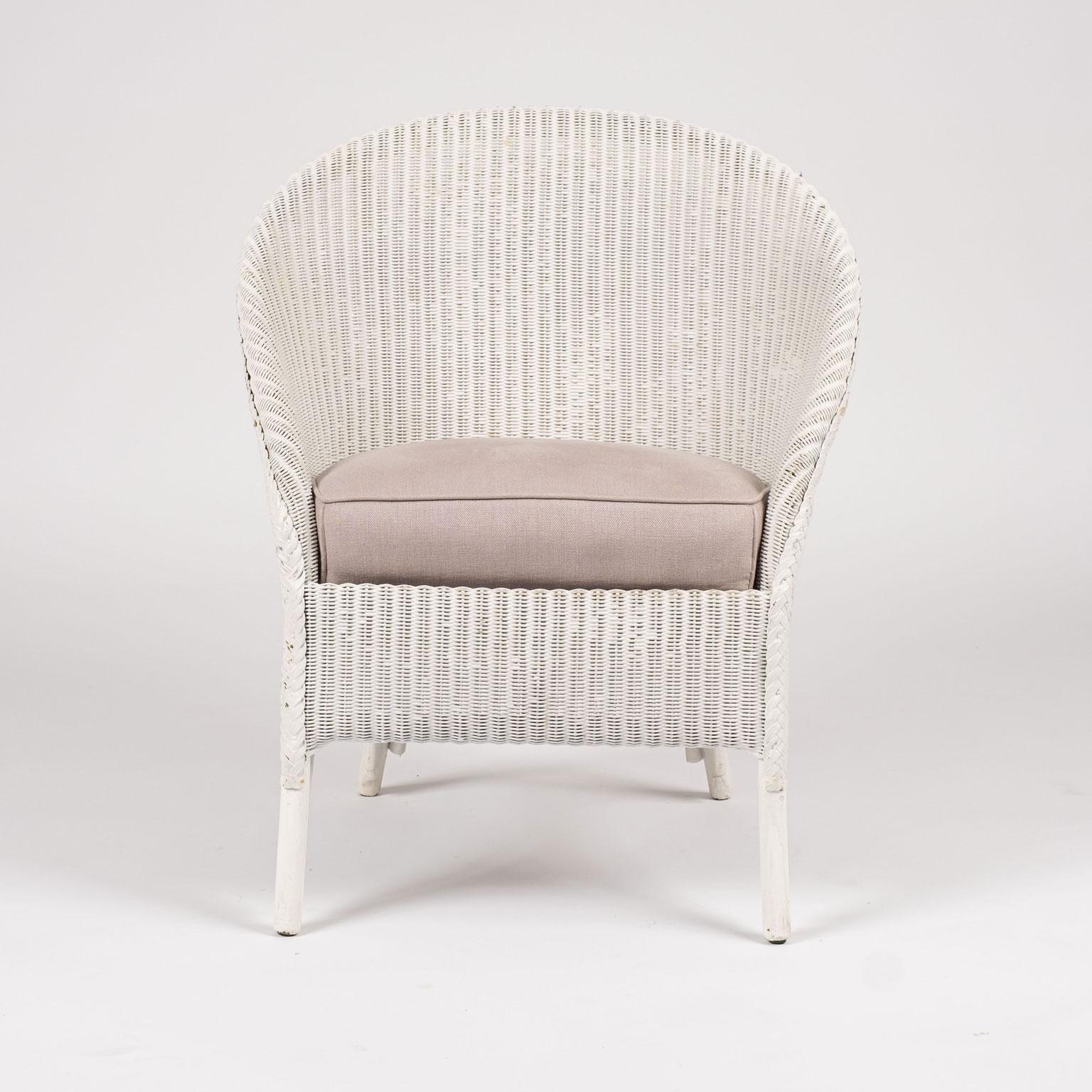 Lloyd Loom style white painted wicker chair. Sturdy, stabile condition with original steel spring seat. Upholstered in light color lavender linen.