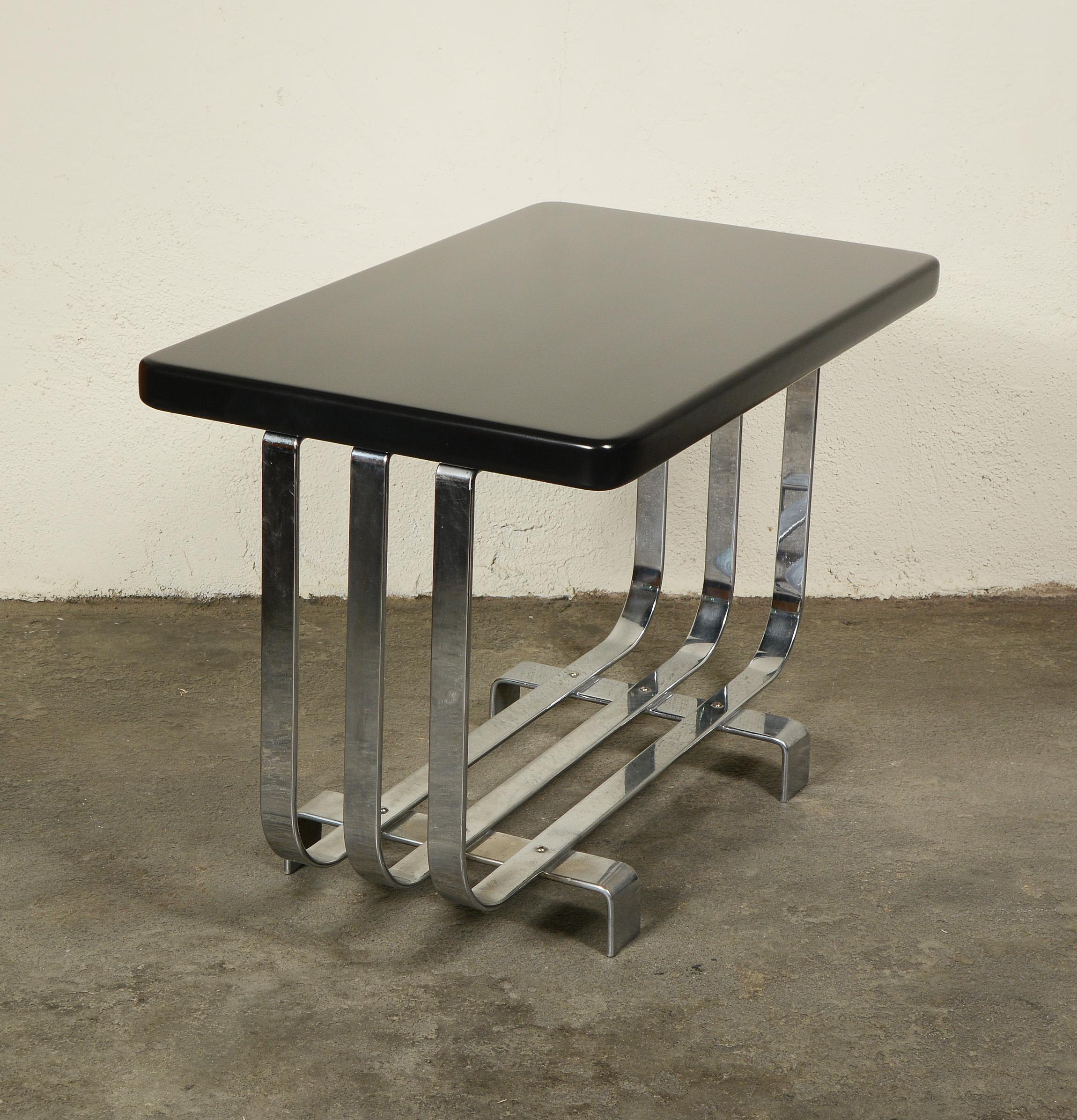 Chrome and lacquered wood Machine Age end table by Lloyd. This design has been attributed to KEM Weber. The chrome shows wear with some scratches and a few areas of pitting.