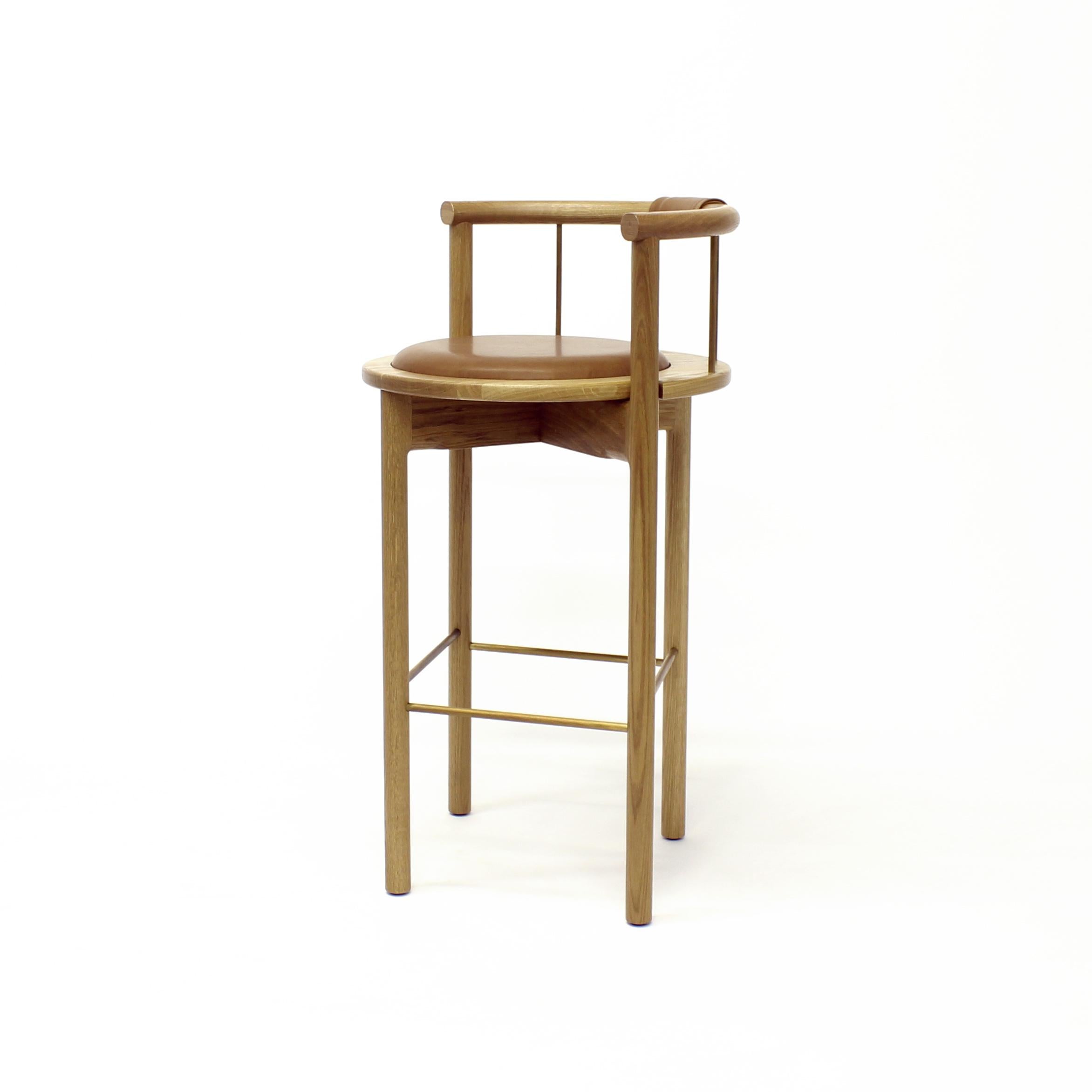 Lloyd bar stool 

Solid wood frame / hand rubbed oil finish / brushed brass, bronze or black rungs / leather wrapped back support / recessed leather seat cushion

Measures: 23” W x 21” D x 39” H (30” seat height)

Also available in counter