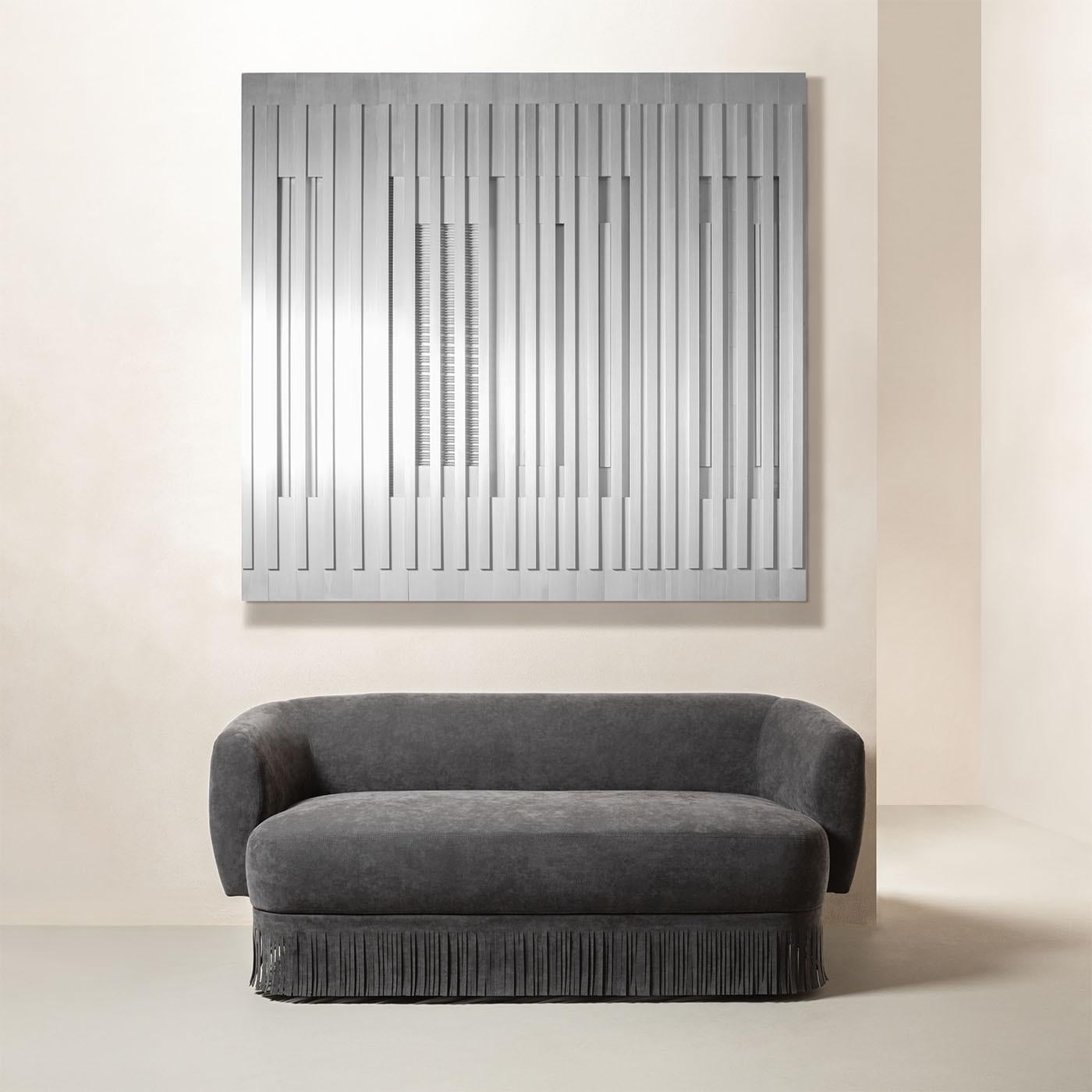 Merging massive volumes with utterly soft and enveloping curves in a captivating aesthetic harmony, this sofa is a perfect blend of clean design and timeless elegance. The sleek and geometric frame is enriched with upholstered leather cushions and
