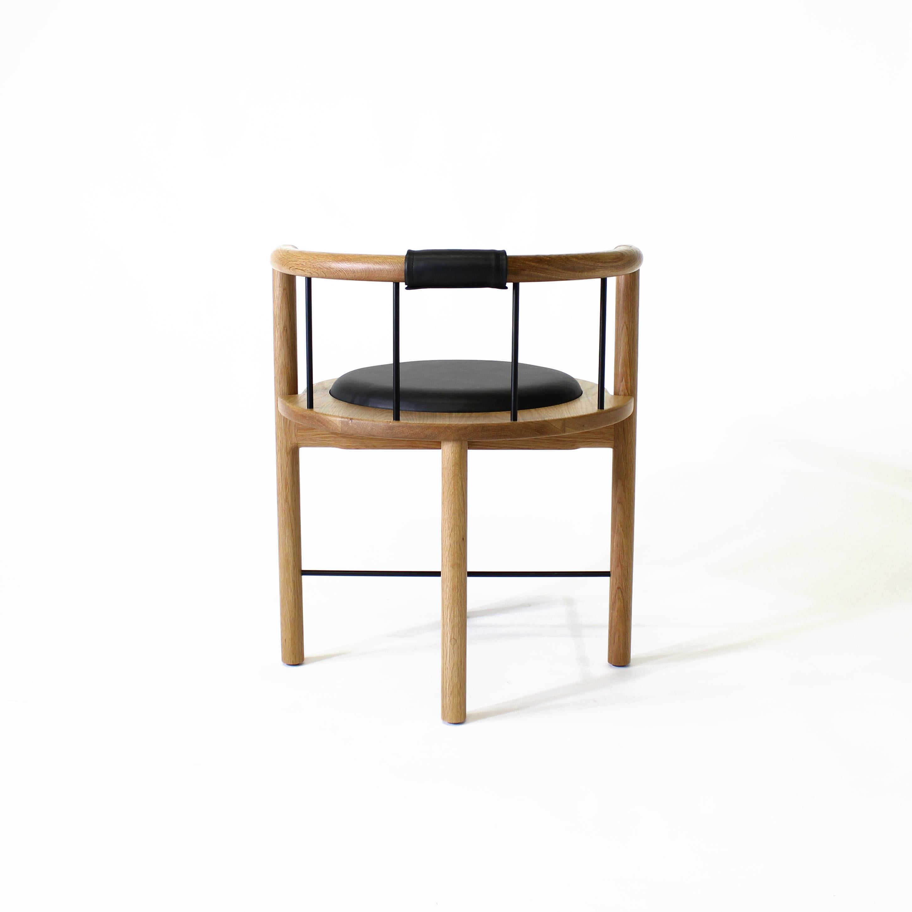 Lloyd Accent chair by Crump and Kwash

Solid wood frame / hand rubbed oil finish / brushed brass or bronze rungs / leather wrapped back support / recessed leather seat cushion

Dimensions:
23”w x 21”d x 27” h (18” seat height)

Upholstery
