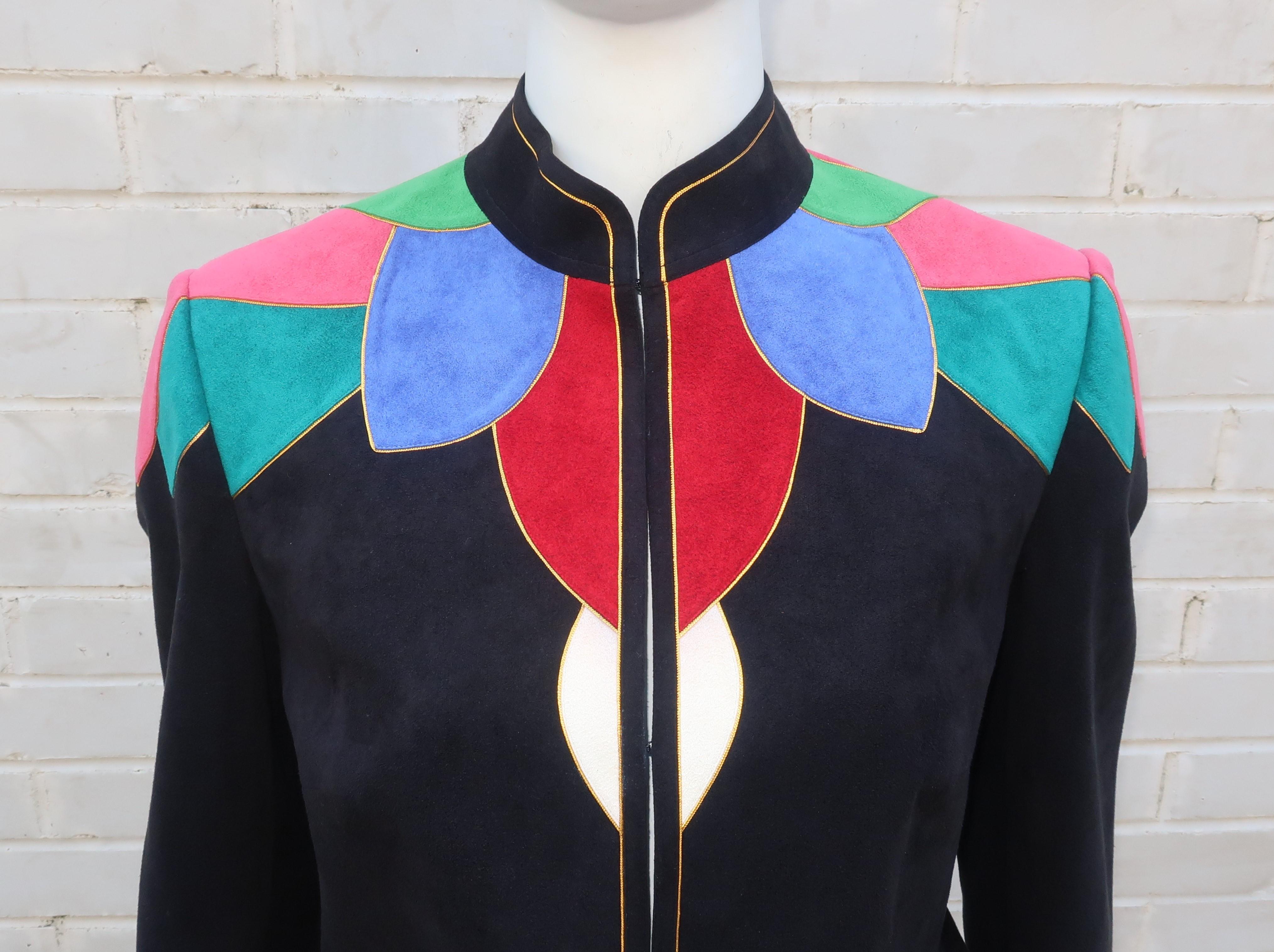 It is all about the jacket with this 1980's Lloyd Williams three piece ultra suede suit.  The black background is perfect to set off a colorful patchwork of greens, blue, pink and red all trimmed in a narrow gold cord resembling a petal design that