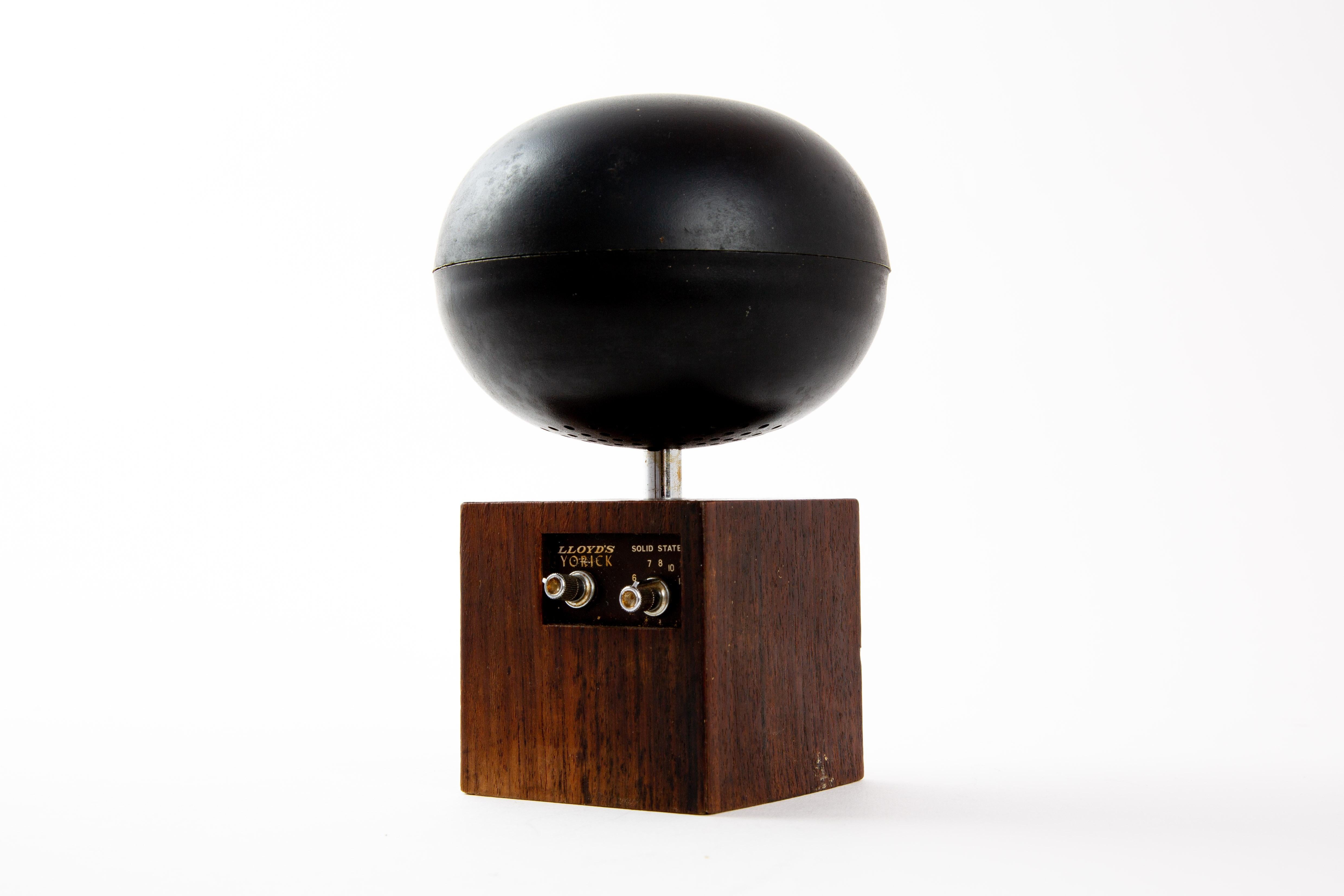 Lloyd's Yorick rare space radio from Japan. The spere is the antenna, and speaker in one. The box is of plastic covered with tropical wood. The radio has not been tested.