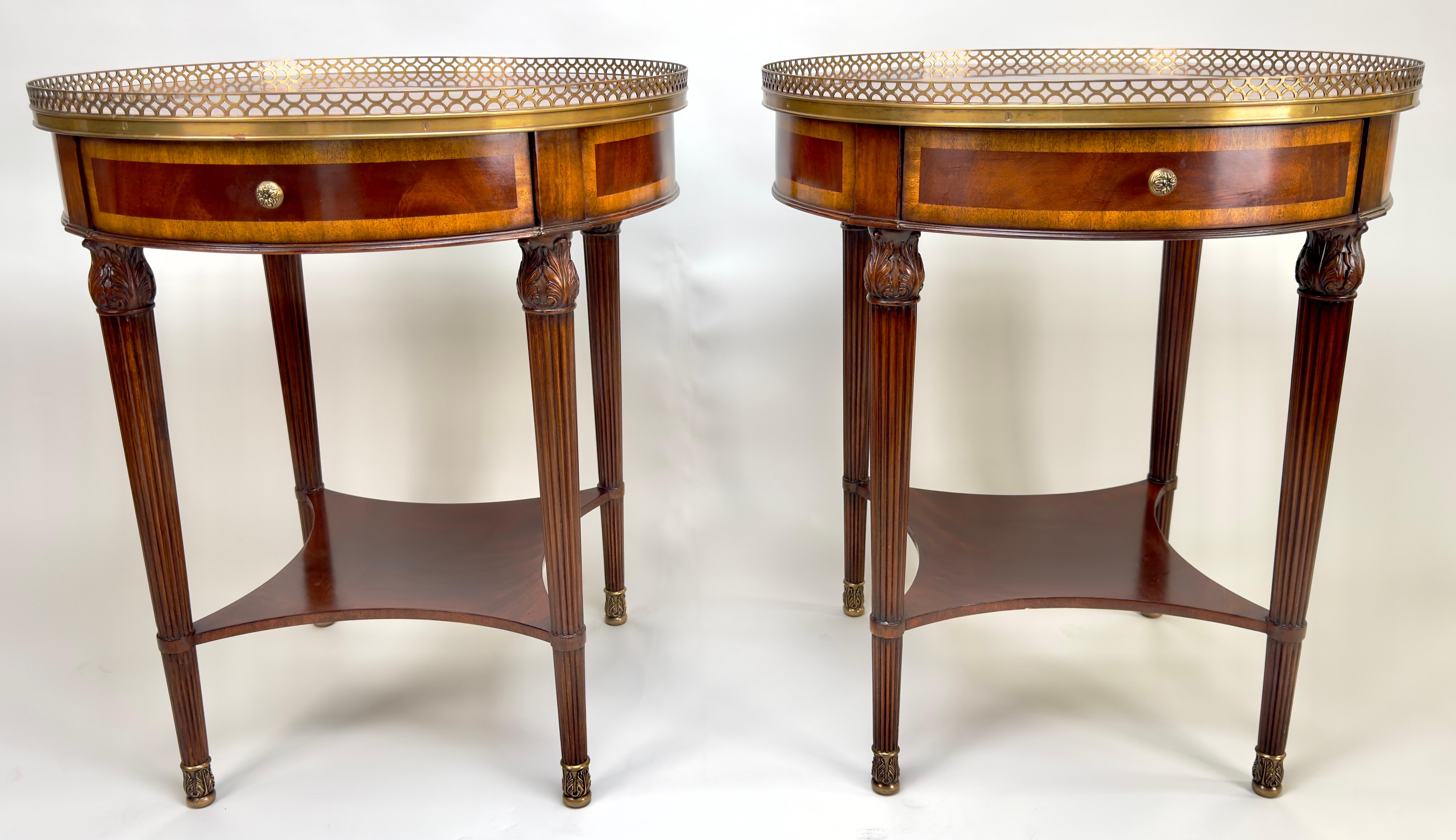 A pair of Louis XVI style bouillotte side or end tables, each a masterpiece crafted from the finest solid mahogany and adorned with delicate mahogany veneer.  At first glance, the eye is drawn to the exquisite belt drawer and its bronze floral knob.