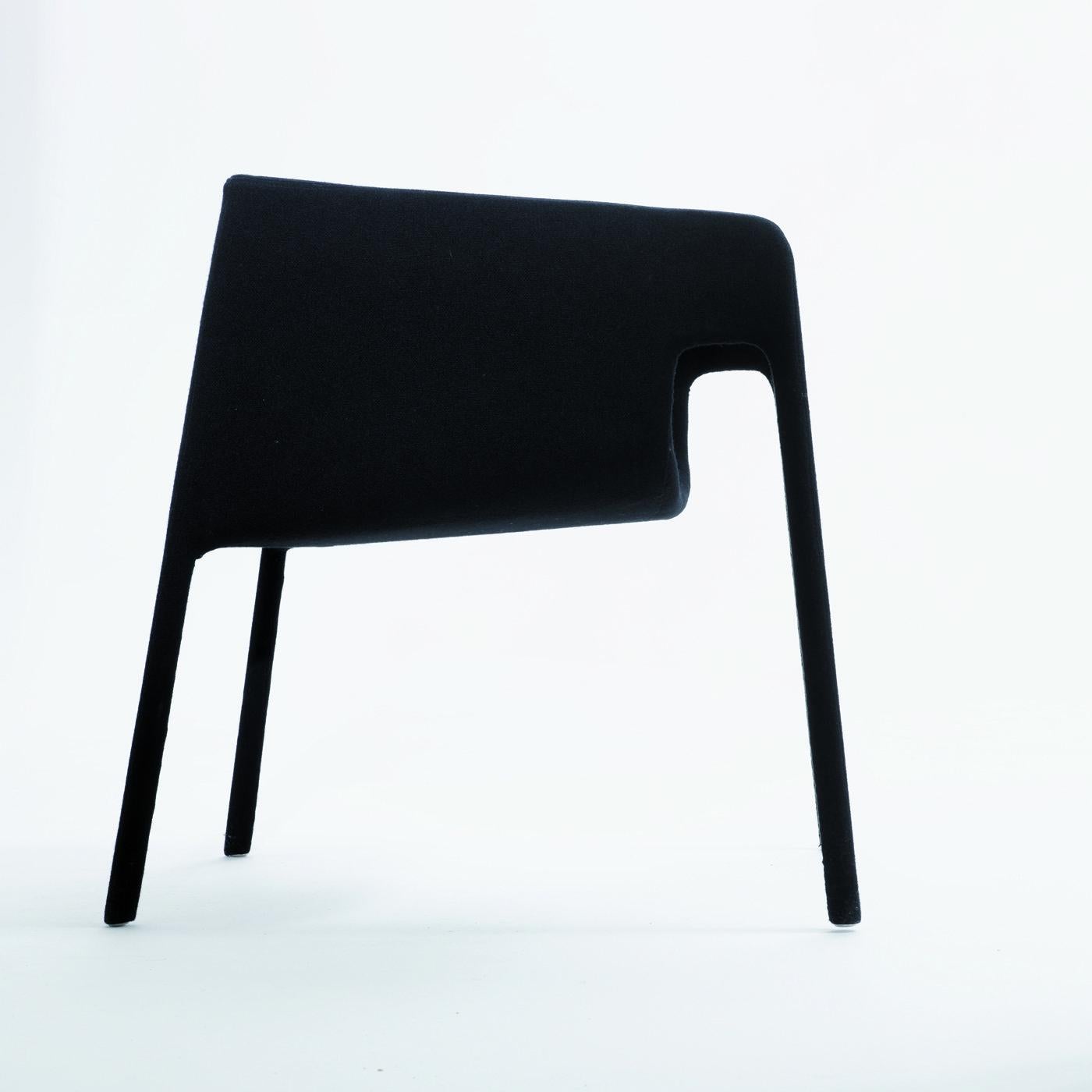 This exquisite chair by StokkeAustad reveals its harmonious balance through the pure lines and soft contours of its unique silhouette. Entirely covered in soft black leather, the unique construction features a curved design on the front that