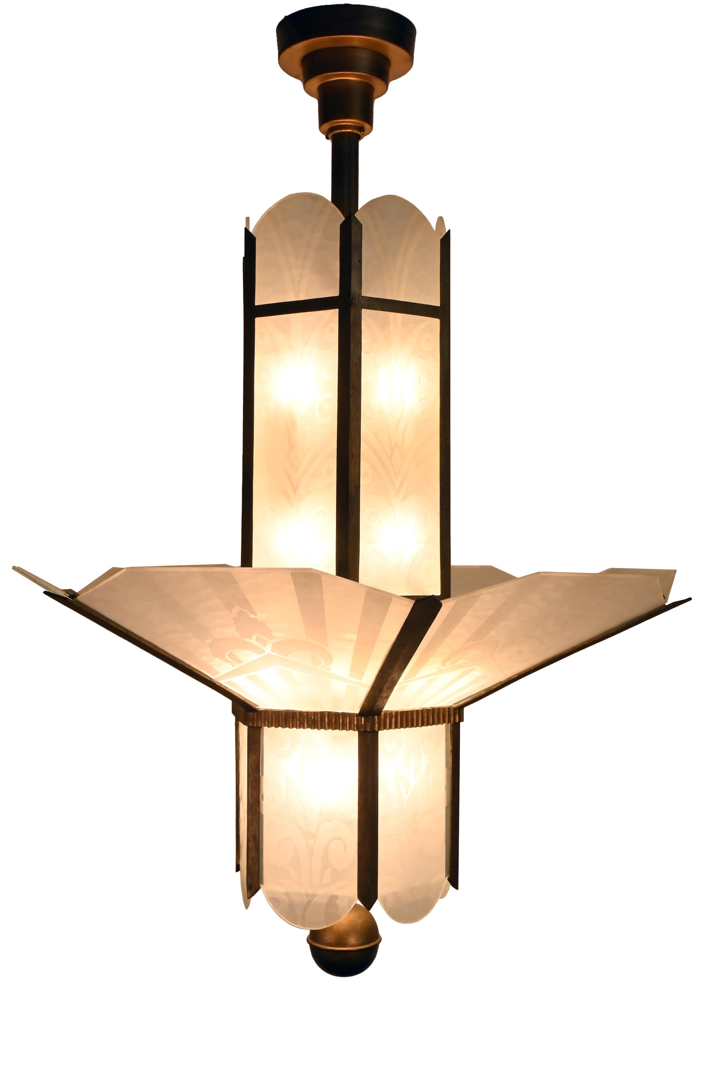 Monumental Art Deco / Art Nouveau Illumination originally from Post Office Lobby.

There are three of this eighteen light chandelier. 

AA# 61219
Circa: 1920's
Condition: Age Consistent
Material: Brass & Molded Glass 
Finish: Original