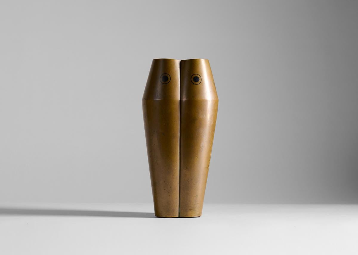 This unusual and restrained bronze vase is comprised of three lobes, each stamped with a disk within a circle motif. Signed.