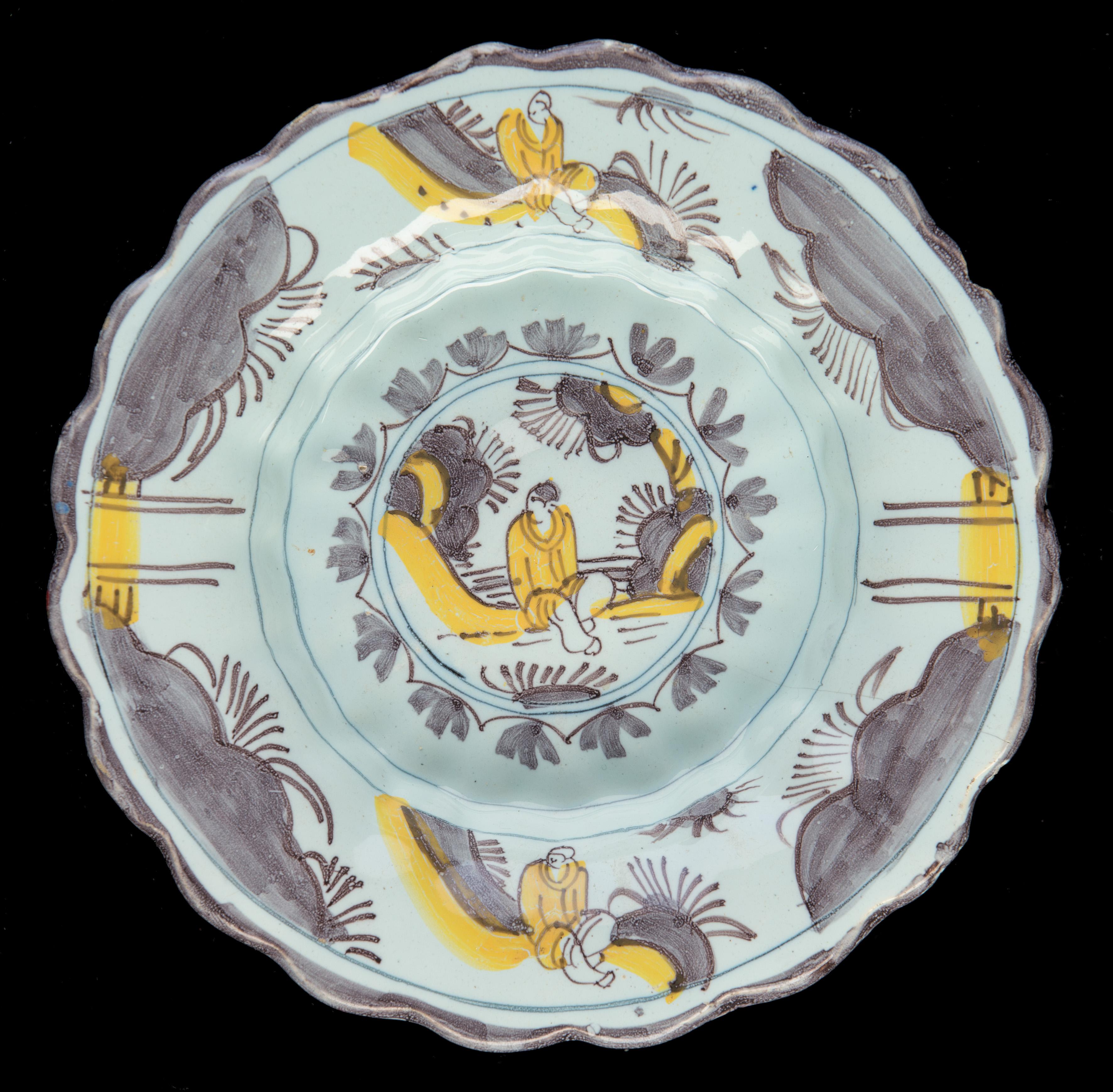 Lobed dish with purple and yellow chinoiserie landscape Delft, 1680-1700
Dimensions: diameter 22 cm / 8.66 in.

The lobed dish is composed of twenty double lobes and is painted in purple and yellow with a simplified chinoiserie landscape. A