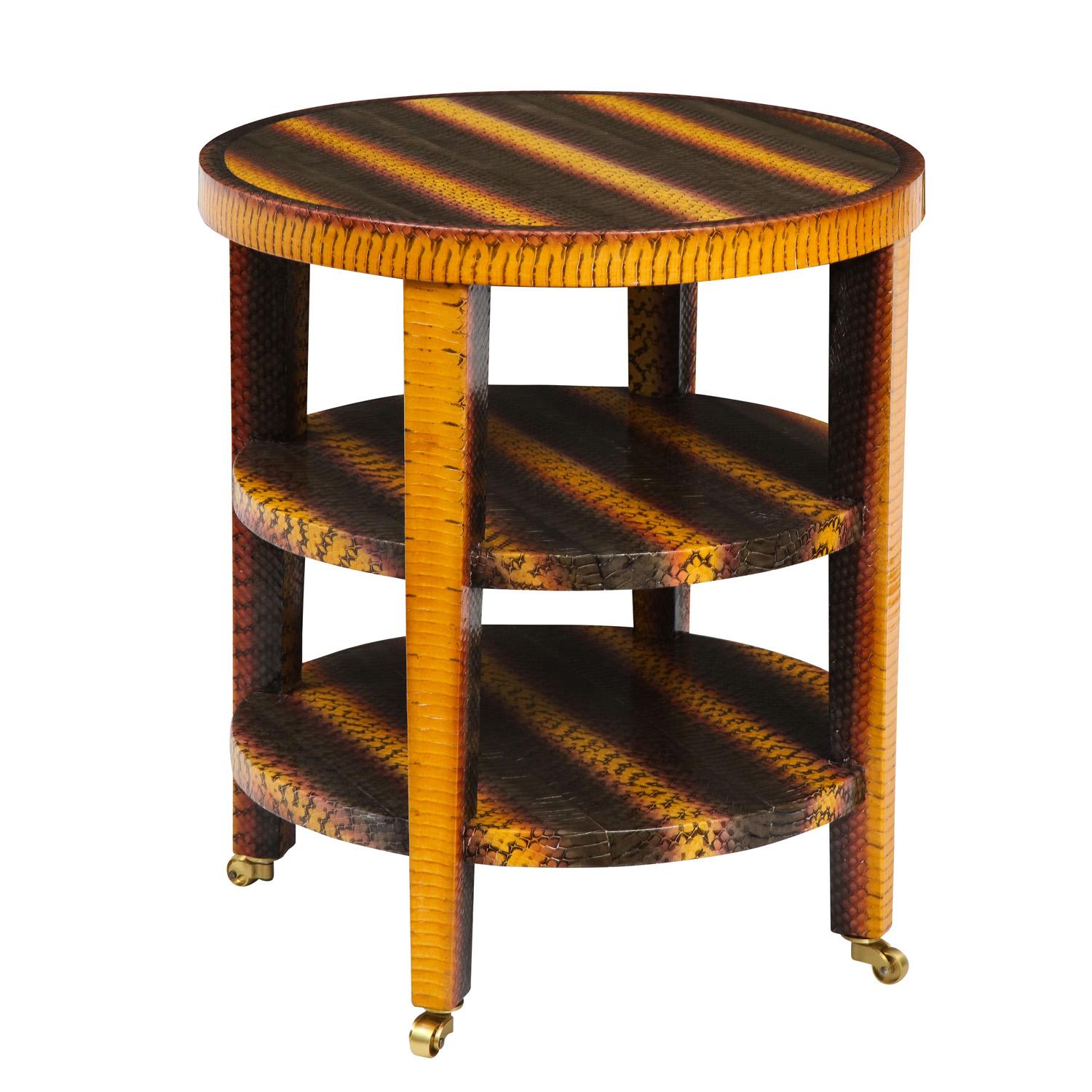 Round 3-tier side table covered in yellow, pink and gray snake skin on brass castors by Evan Lobel for Lobel Originals, American 2022. The colors and craftsmanship of this table are exceptional.