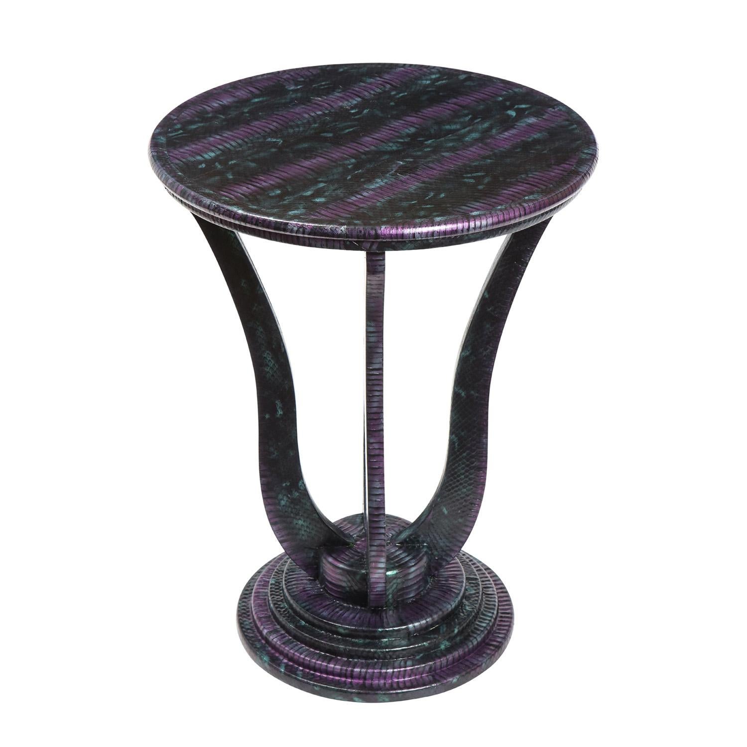 Round side table with stepped base and curved vertical elements in purple, black and teal snake skin by Evan Lobel for Lobel Originals, American 2021. The colors of this table are exquisite and the craftsmanship is exceptional.