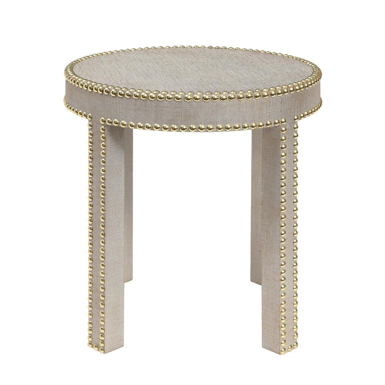 Round side table covered in platinum lacquered linen with brass studs around top and legs by Evan Lobel for Lobel Originals, American 2021.