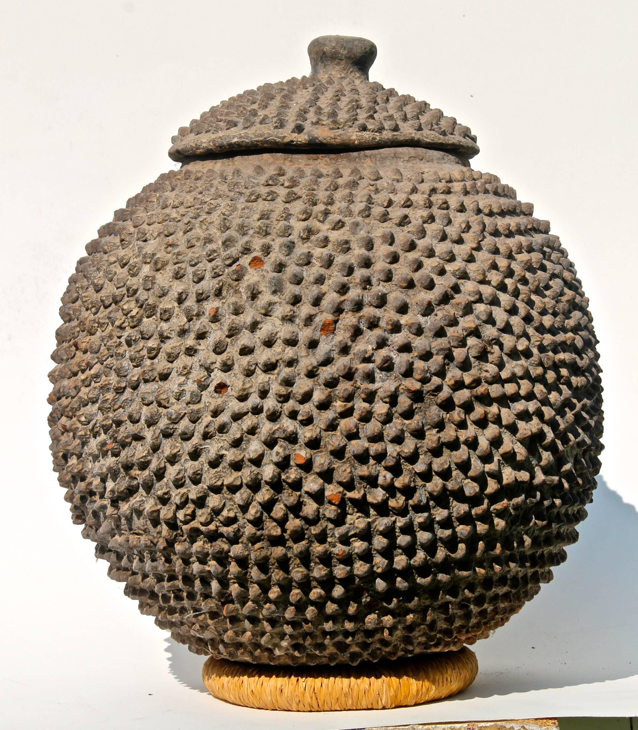 A very large and heavy globular bowl, rounded bottom and with its lid.