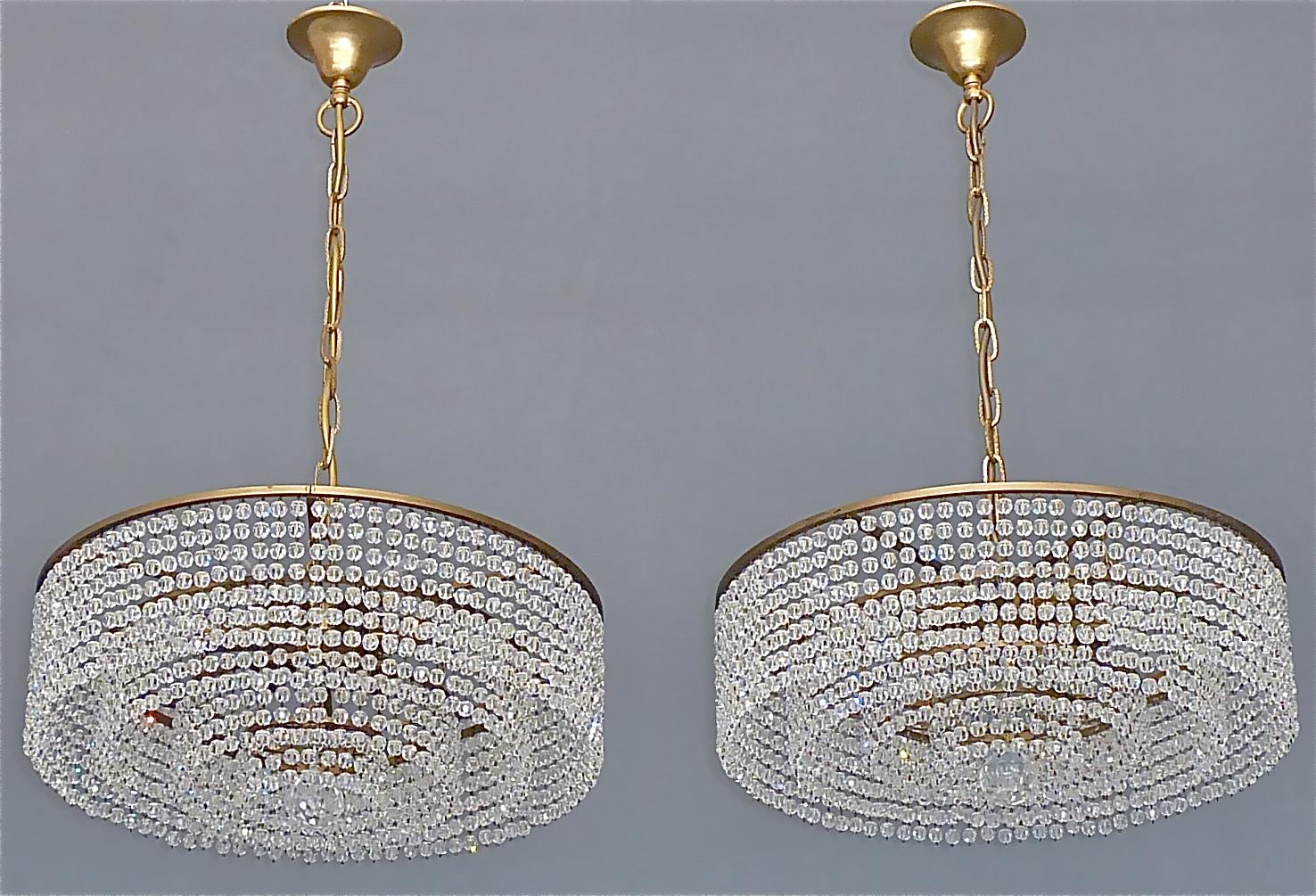 Beautiful Lobmeyr attribution patinated brass and crystal glass chandelier Austria, Vienna, circa 1950s. It has four rings and additional a center crystal with high lead and hand-cut faceted crystal pearl strings which sparkle like diamonds. This