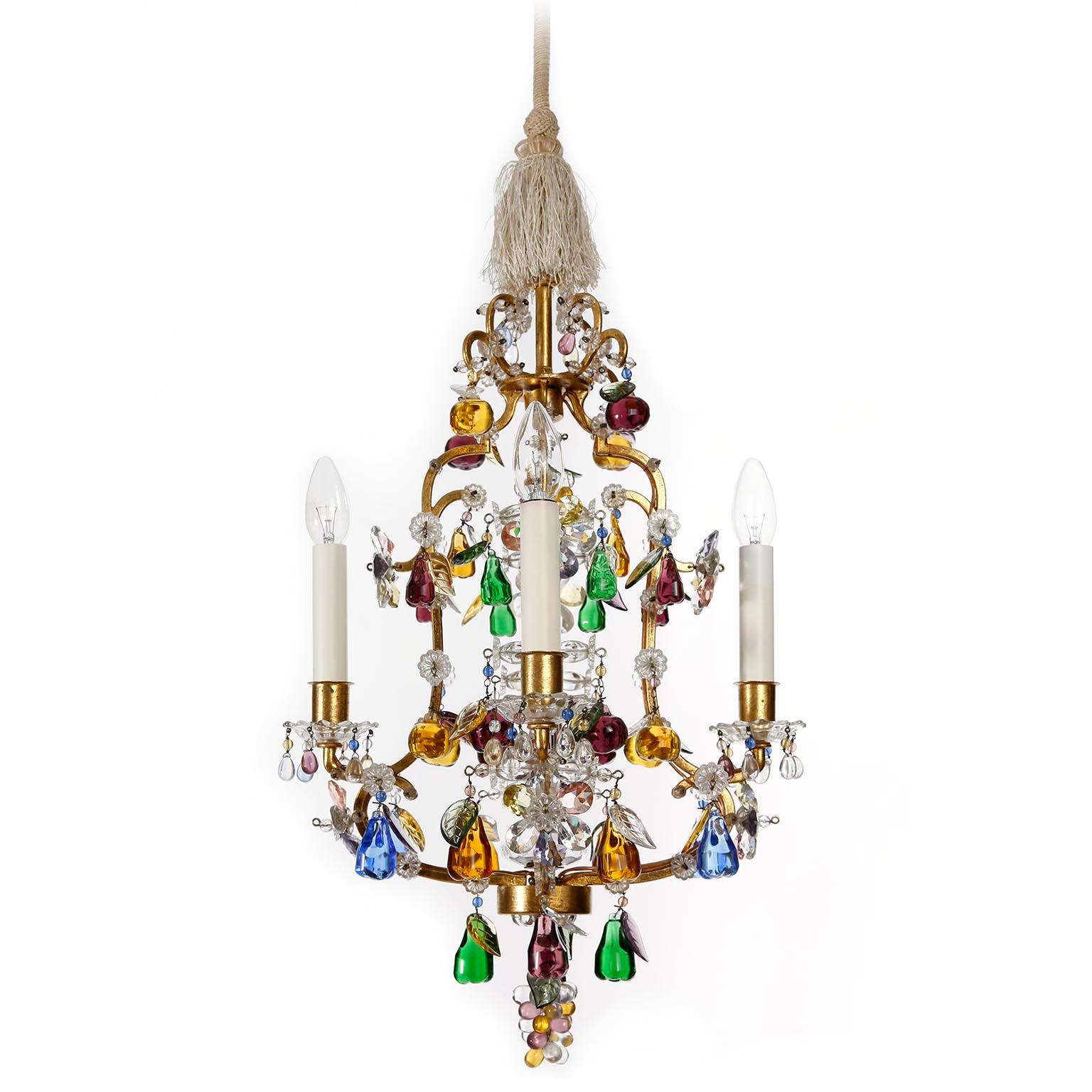 A chandelier from the 'fruit'-series by J. & L. Lobmeyr, Austria, Vienna, manufactured in midcentury, circa 1950.
It is made of leaf gold plated metal frame decorated with colorful glass fruits and clear cut glass. The fruits are apples, pears and