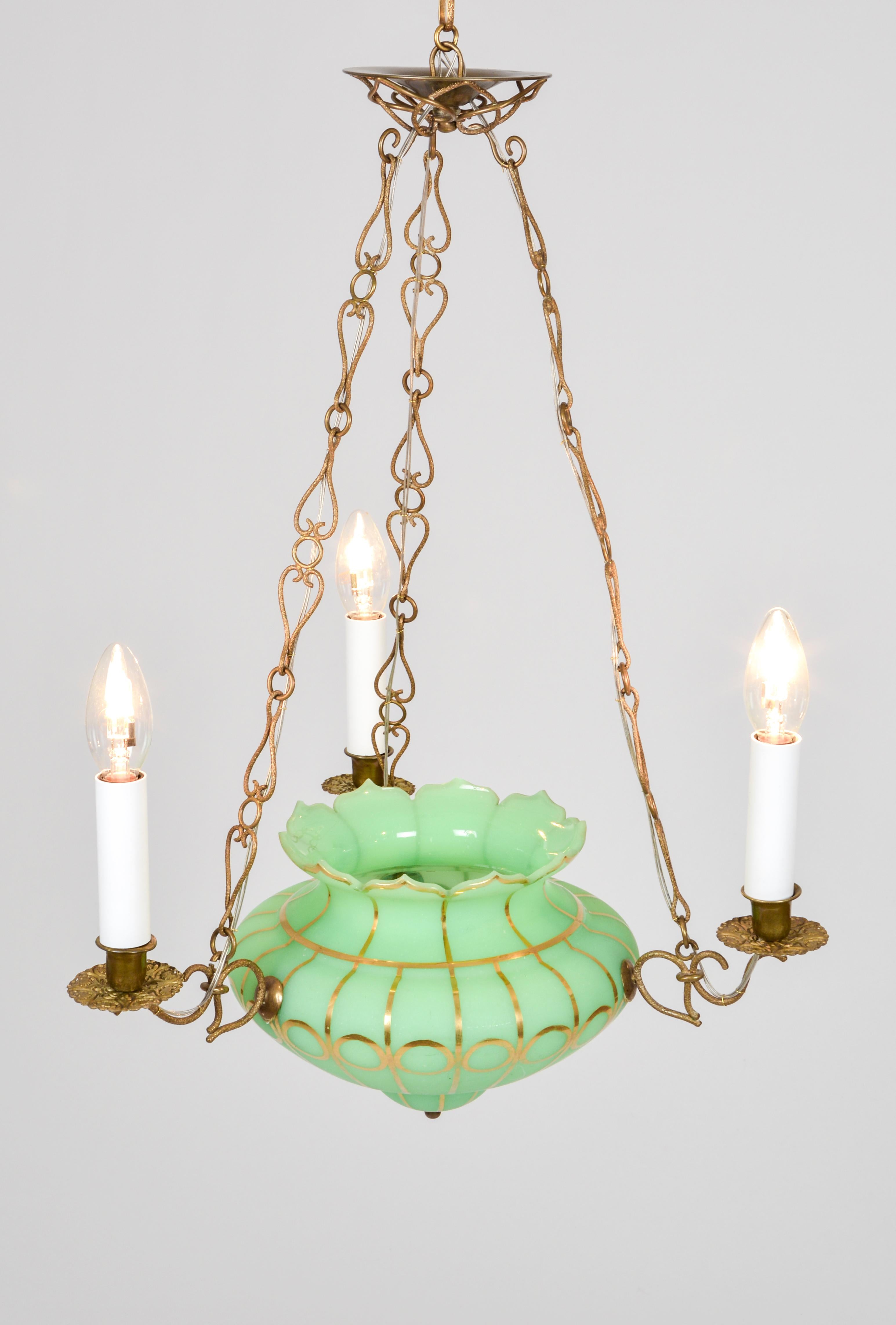 This classical Biedermeier pendant lamp features a gold-painted glass vase of bright-green milk glass. The brass applications and suspensions are cast and embossed with an antique gold finish. It makes a perfect centre piece in a small drawing room