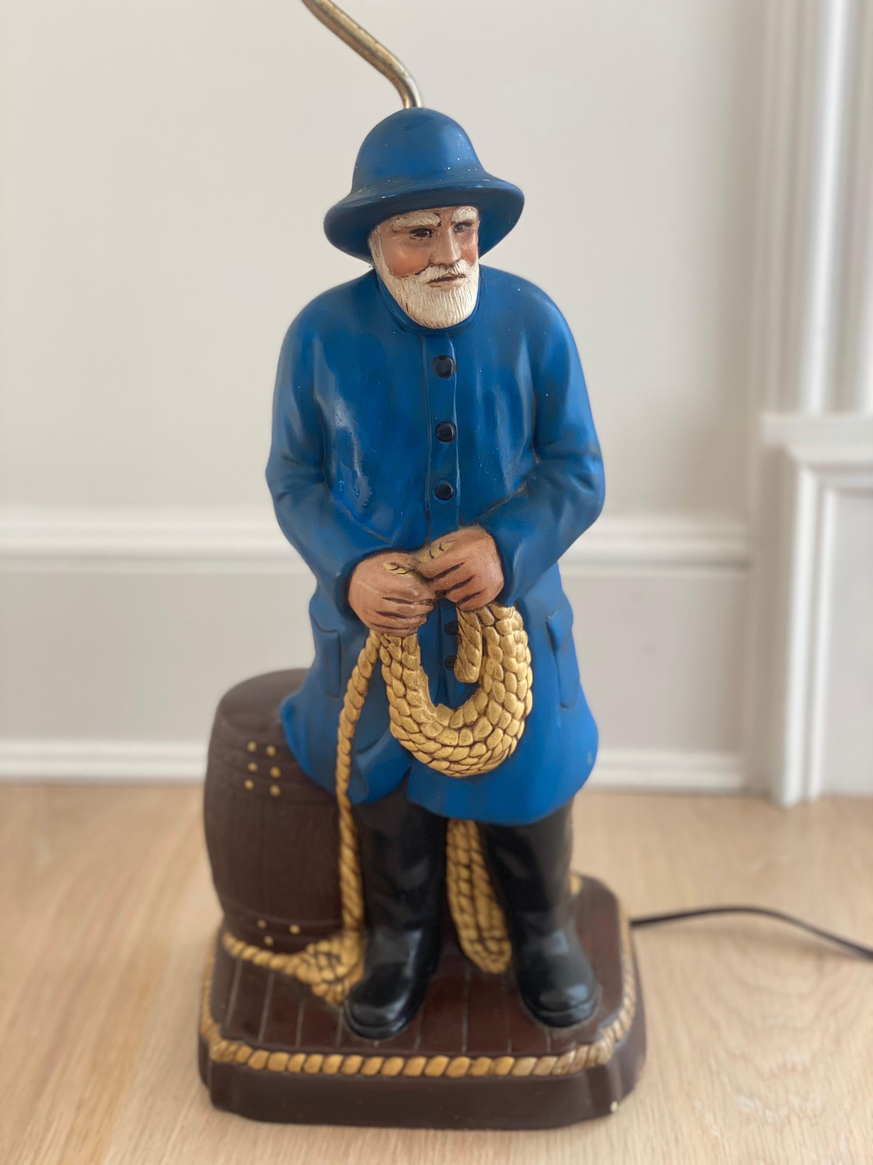 Lobster Man porcelain lamp
Lobster Man or Fisherman in blue slickers holding a rope next to an oak barrel. No shade. Good overall condition.
8.25” deep x 7” wide x 23.25” high top of light bulb x 32” top of harp.