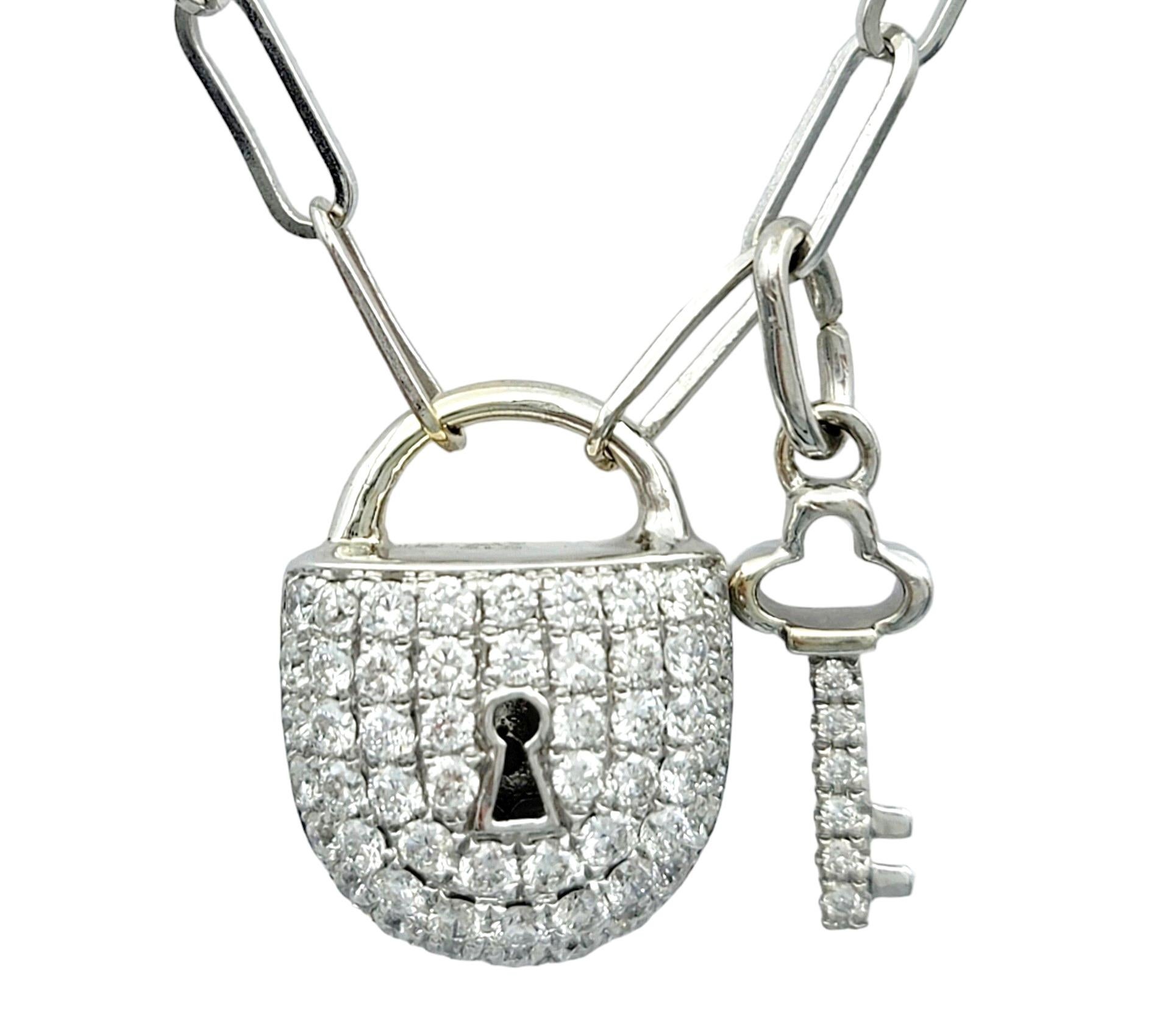 This diamond-encrusted lock and key pendant necklace is a beautiful work of art. The necklace is set in lustrous 18 karat white gold, adding a touch of luxury to its design. Adorned with a dazzling array of pave diamonds, the pendant sparkles with