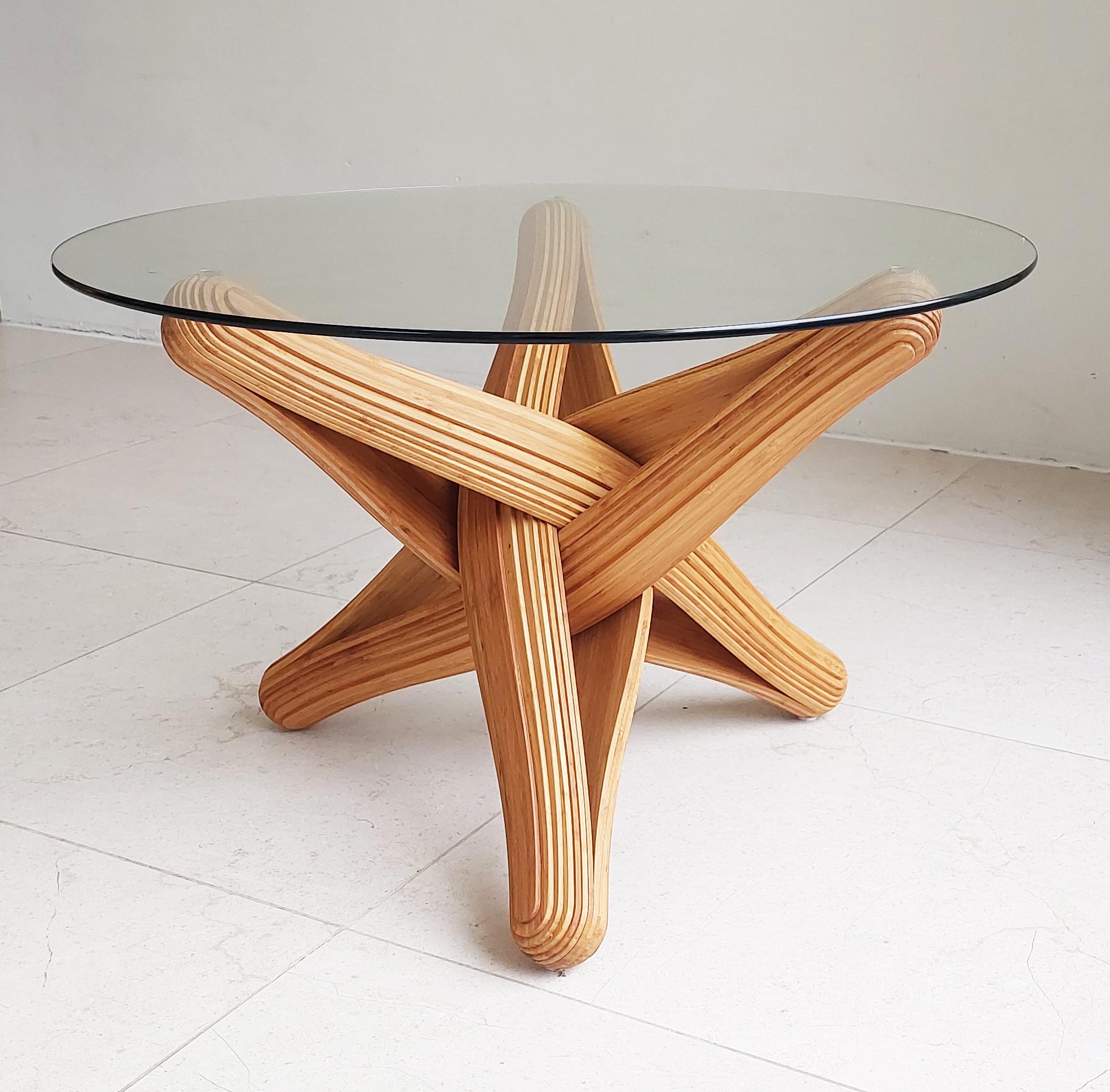 “Lock” coffee table is designed out of the qualities, possibilities and characteristics of its material: Bamboo. The frame is build by hand from pressed layers of flexible bamboo. 
The bamboo is heated and caramalised to give it a beautifull caramel