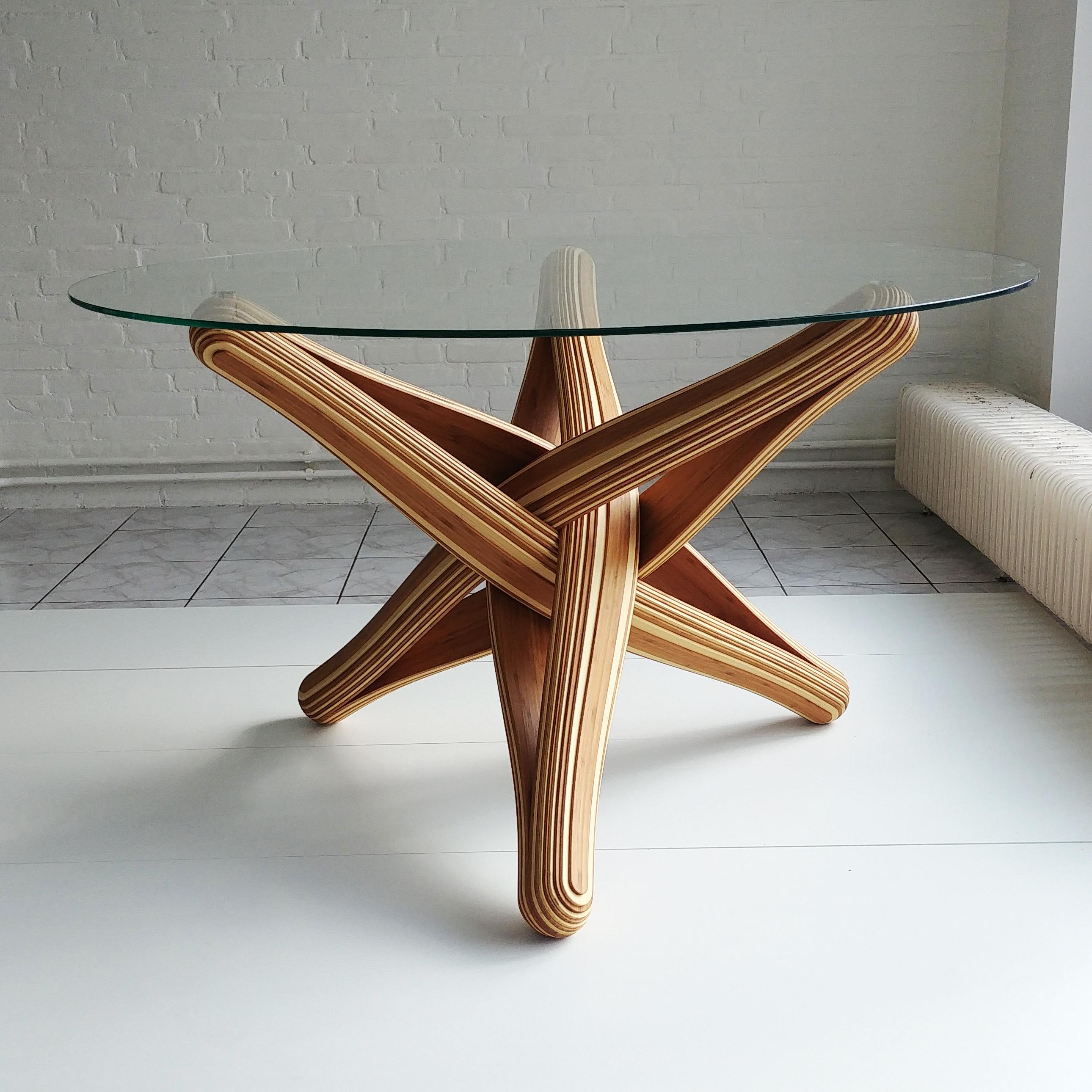 “LOCK” sculptural bamboo dining table is designed out of the qualities, possibilities and characteristics of its material: bamboo.  The frame is build up from pressed layers of flexible bamboo. The shape is formed by the bamboo’s natural bending