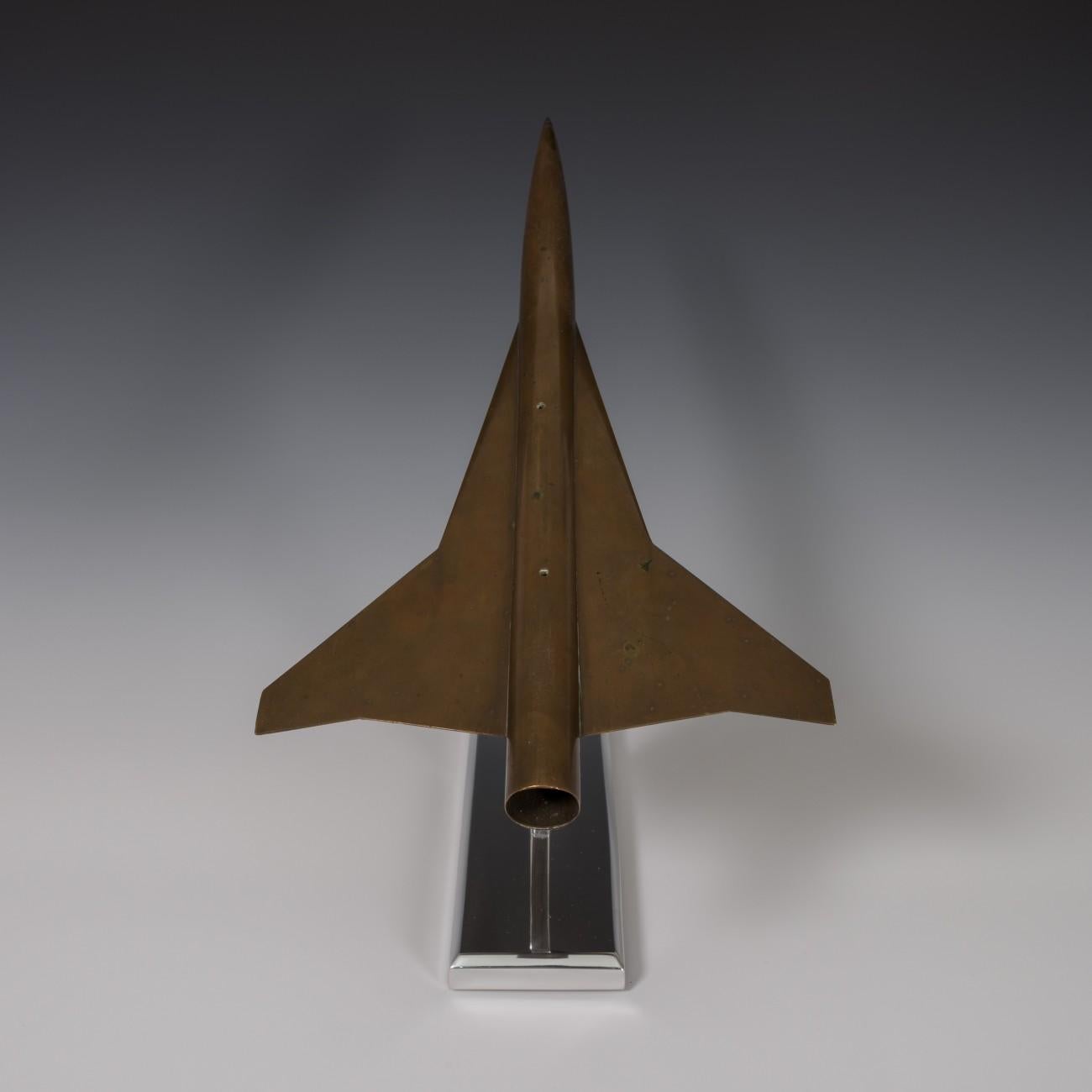 A rare scale model of the Lockheed L-2000 made for use in a wind-tunnel to assess aerodynamic characteristics, circa 1960. The model was made in brass which has developed a patina that is more like the color of bronze. The aircraft sits on a newly