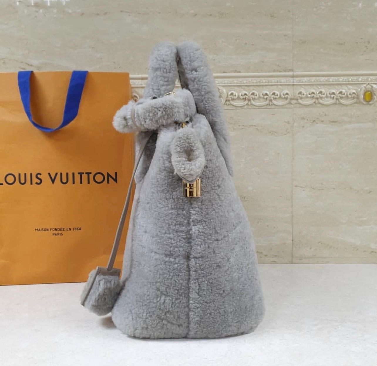Louis Vuitton Shearling Pulsion Lockit Bag.
 From the fall/winter 2011 Collection.
 Grey Shearling with brass hardware, dual flat top handles, grey leather interior, single slit pocket at interior wall and zip closure at top. 
No box. No dust bag.