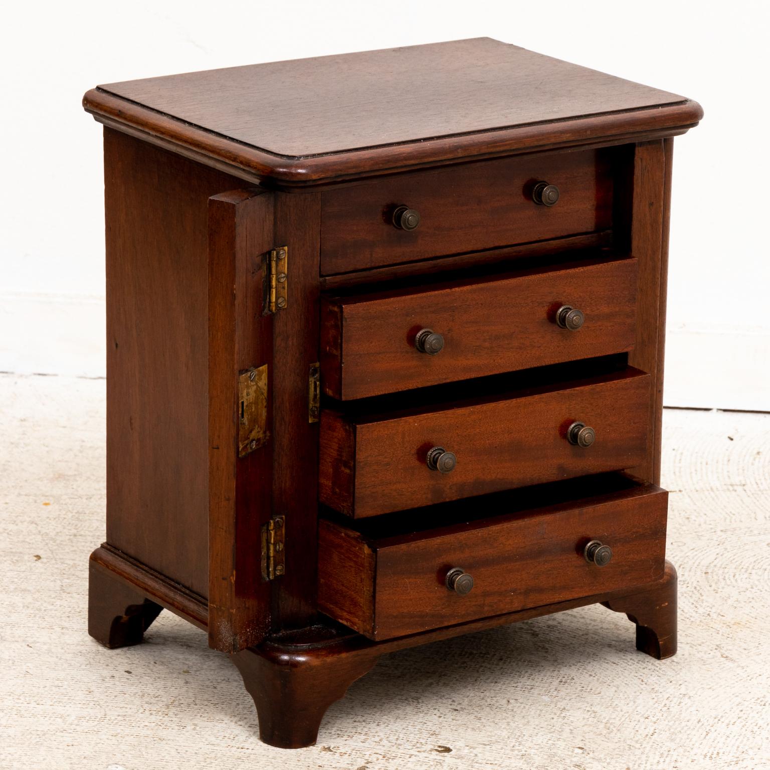 Circa 1840s Lockside four drawer salesman's sample size mahogany chest with key. Made in England in the 19th century and crafted for portable use. Please note of wear consistent with age.