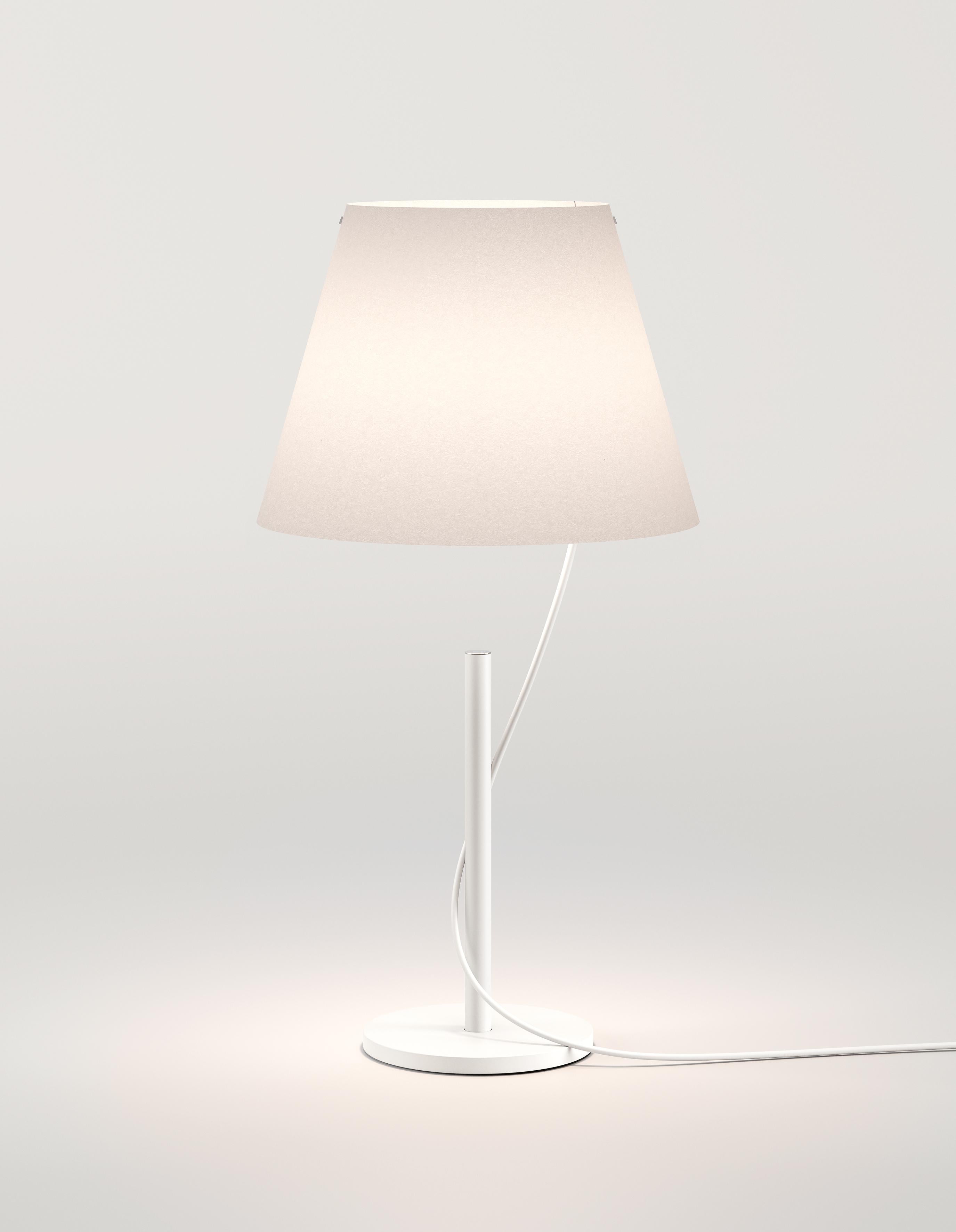 The Hover table and floor lamps feature a lamp shade that looks as if it is detached from the base, connected seamlessly by a single cable that runs through the stem and comes out of the other end. The end result creates an illusion that the light
