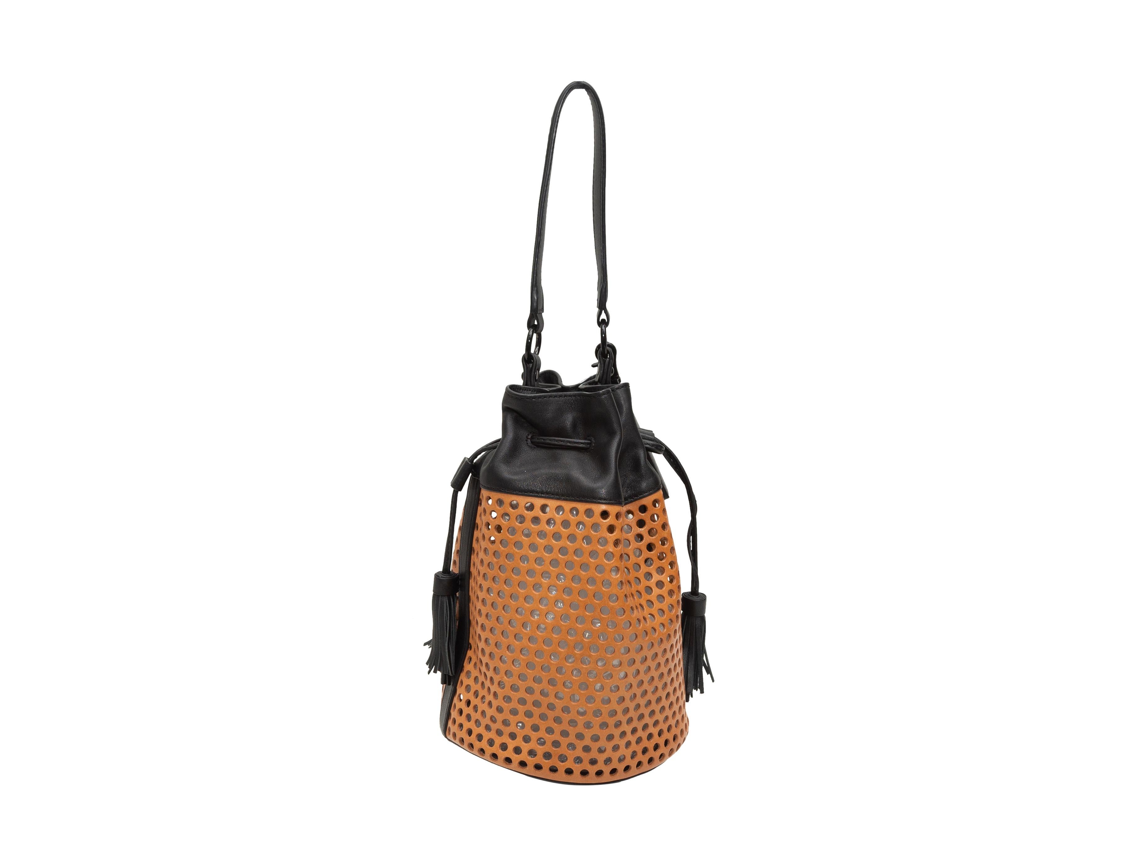 Product details: Tan & Black Loeffler Randall Perforated Leather Bucket Bag. This bag features a leather body, black hardware, a single flat handle, optional shoulder strap, and a drawstring closure at the top. 9