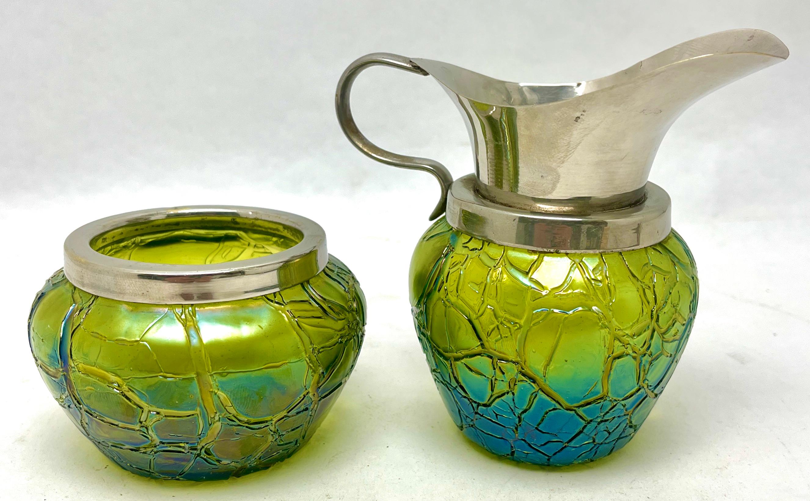 Loetz Art Nouveau cream jug and sugar bowl with details of Irradiated glass.

Beautifully decorated whit Irradiated glass.
Rare to find with original condition.

The piece is in good condition and a real beauty!
Photography fails to capture
