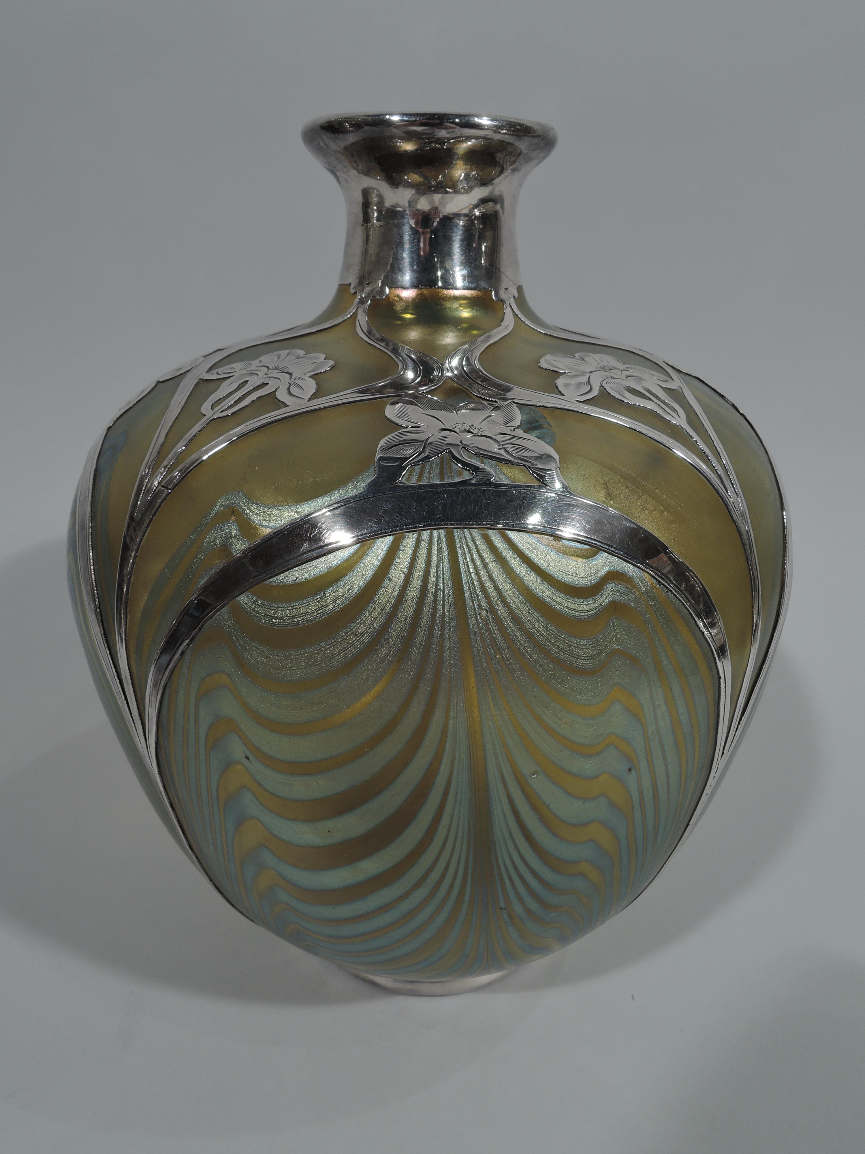 Art Nouveau iridescent yellow glass vase in Phänomen pattern by historic maker Loetz, circa 1900. Ovoid on inset foot ring, with short neck and narrow mouth. White feathering framed by engraved and overlaid silver in form of fluid lines and flowers.