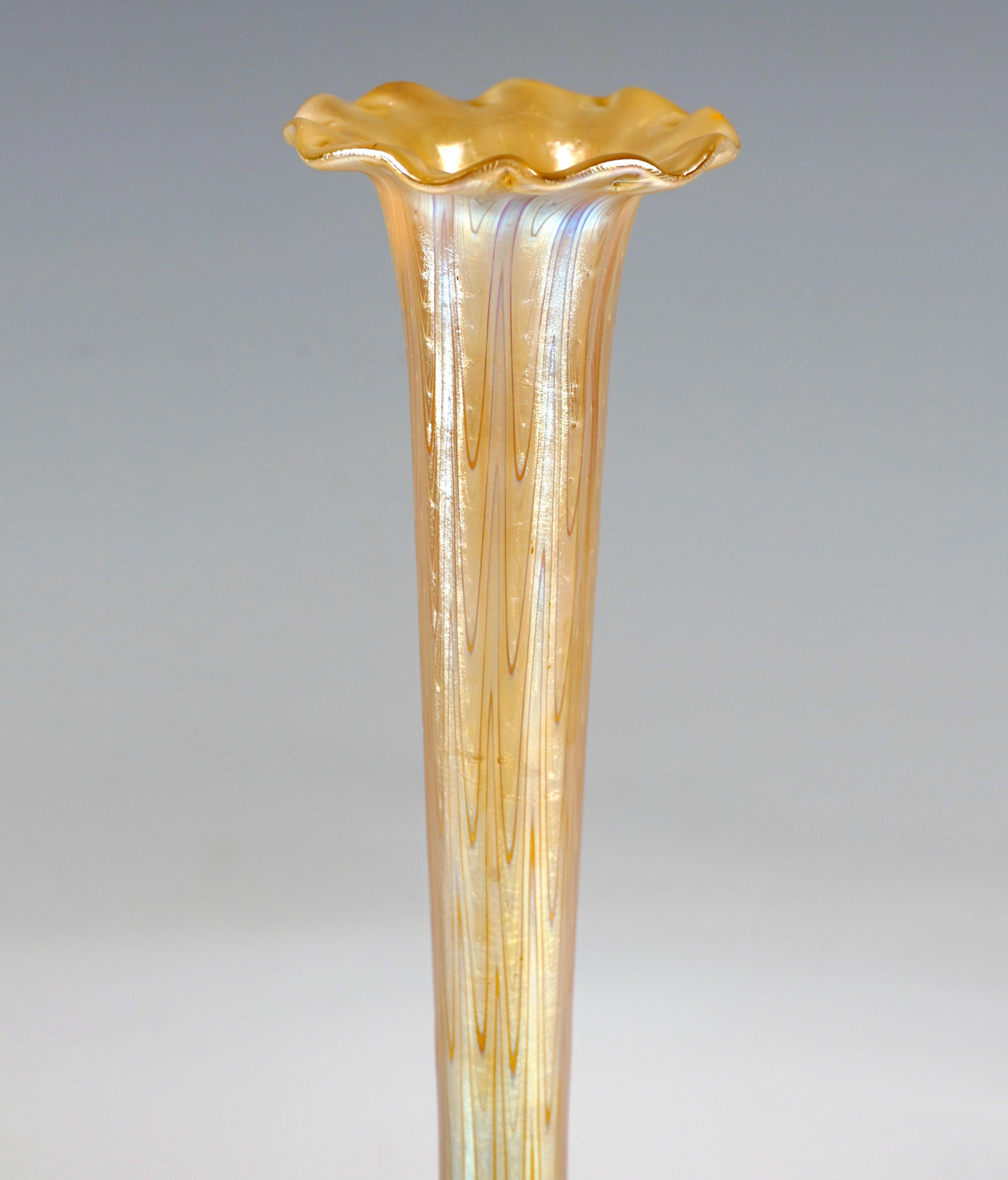 Finest Bohemian Art Nouveau glass vase:
Mold-blown, disc-shaped body on a flush stand with raised, slender, trumpet-shaped, widening neck, flatened, 10-times wave-shaped mouth rim, slightly concave inwardly curved base with ground, polished