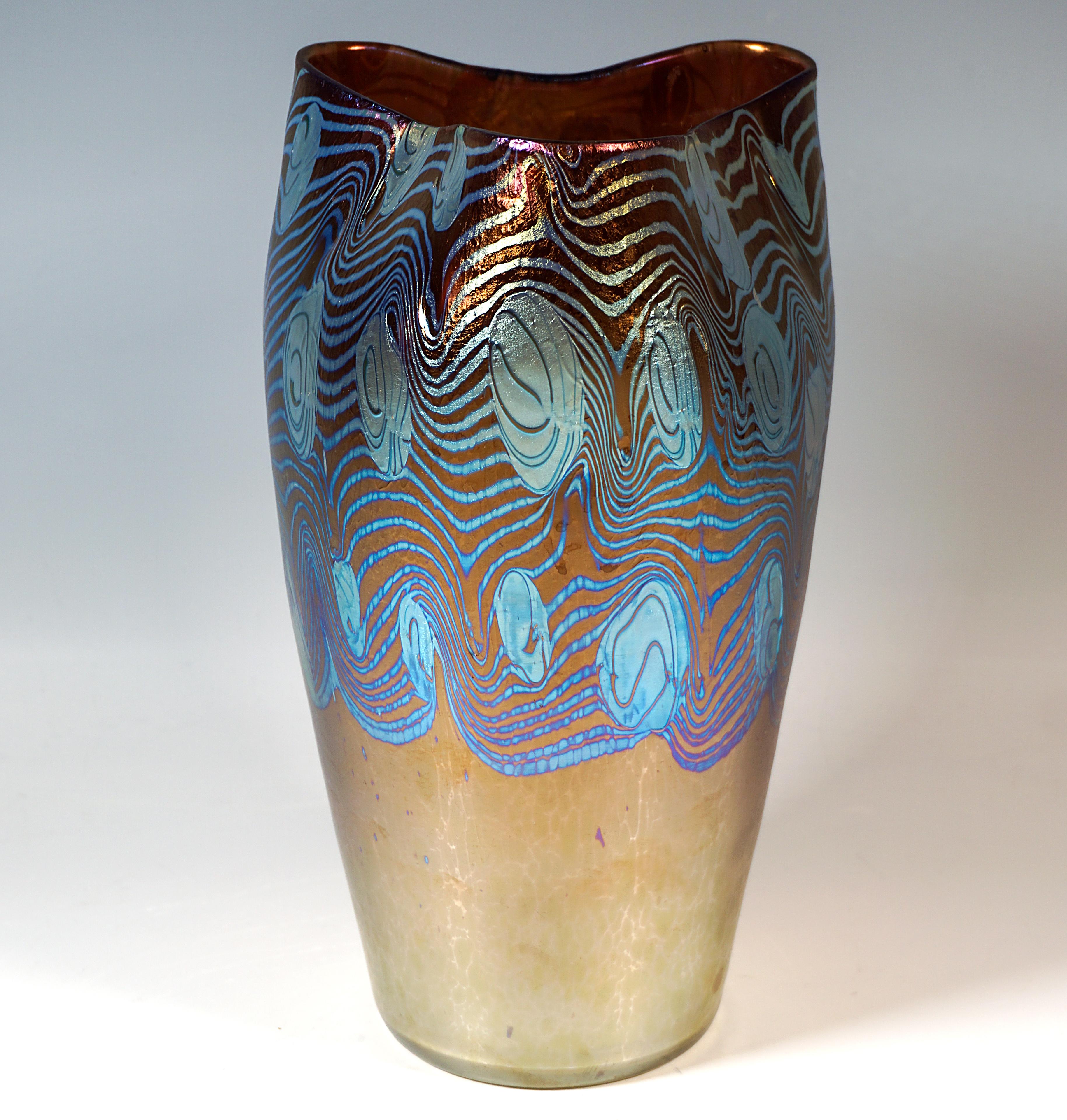Mould blown body widening conically towards the top on a flush round base, the rim shaped into a trefoil by impressions, polished pontil.

Form: Prod. No. - PN 2/603, year 1902

Decor: 'Argus' chestnut Phenomeneon Genre - PG 2/351, year