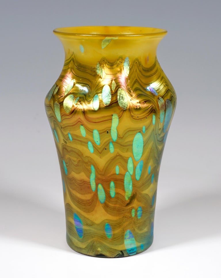 Finest Bohemian Art Nouveau glass vase in the form of a blown, baluster-shaped body with a neck pressed five times and a flared, flat rim of the mouth.

Shape: Production number PN 2/527 with plane mouth rim, year 1902

Decor: Metallic yellow