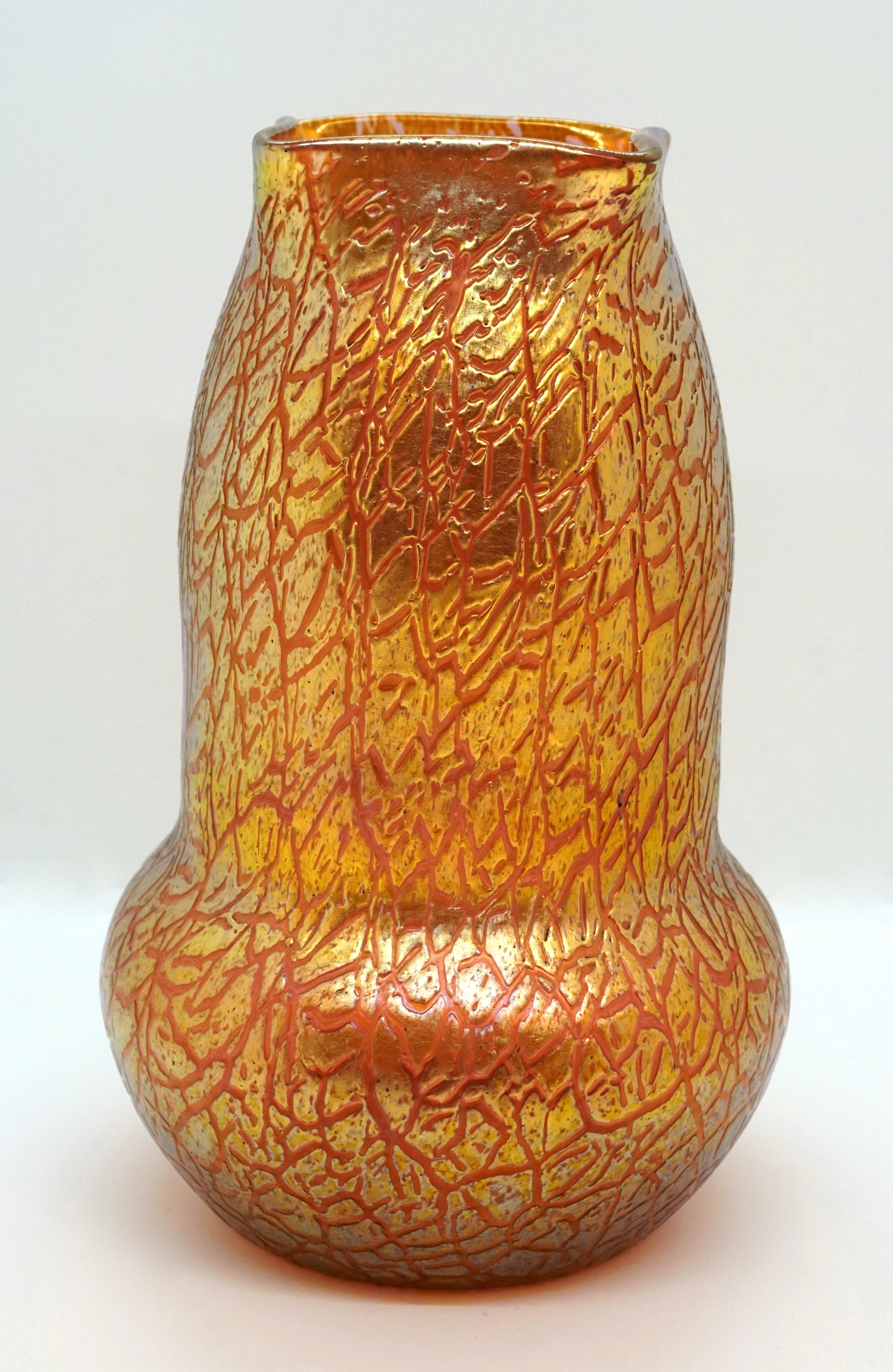 Finest Bohemian Art Nouveau glass vase

Blown, bulbous body on a round floor plan with a wide neck, narrowed at the top and indented four times to create a square opening on the lip rim

Shape: Series II (5000-series) circa 1907

Decor: