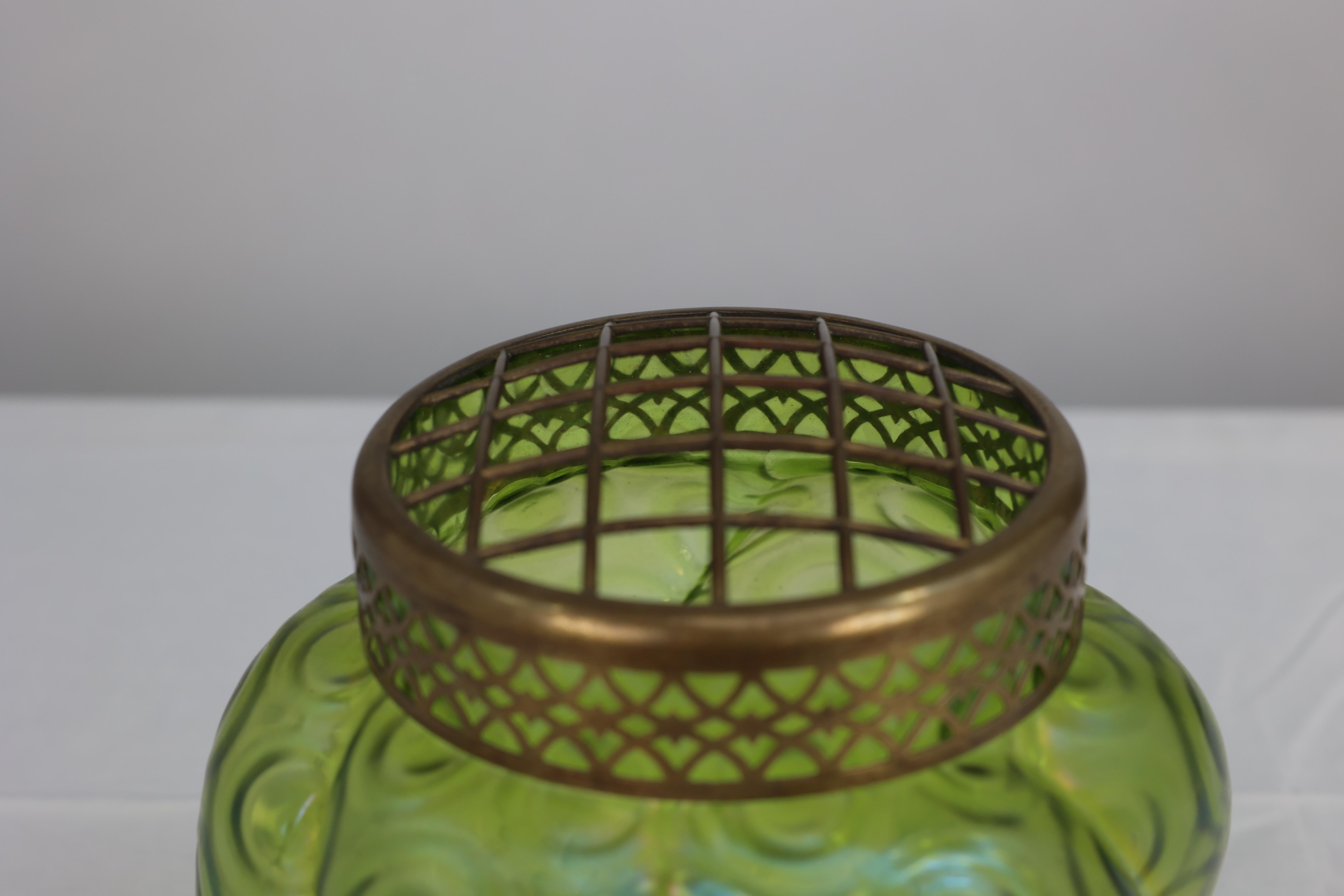 20th Century Loetz (attributed). A green swirl glass flower holder with decorative brass top For Sale