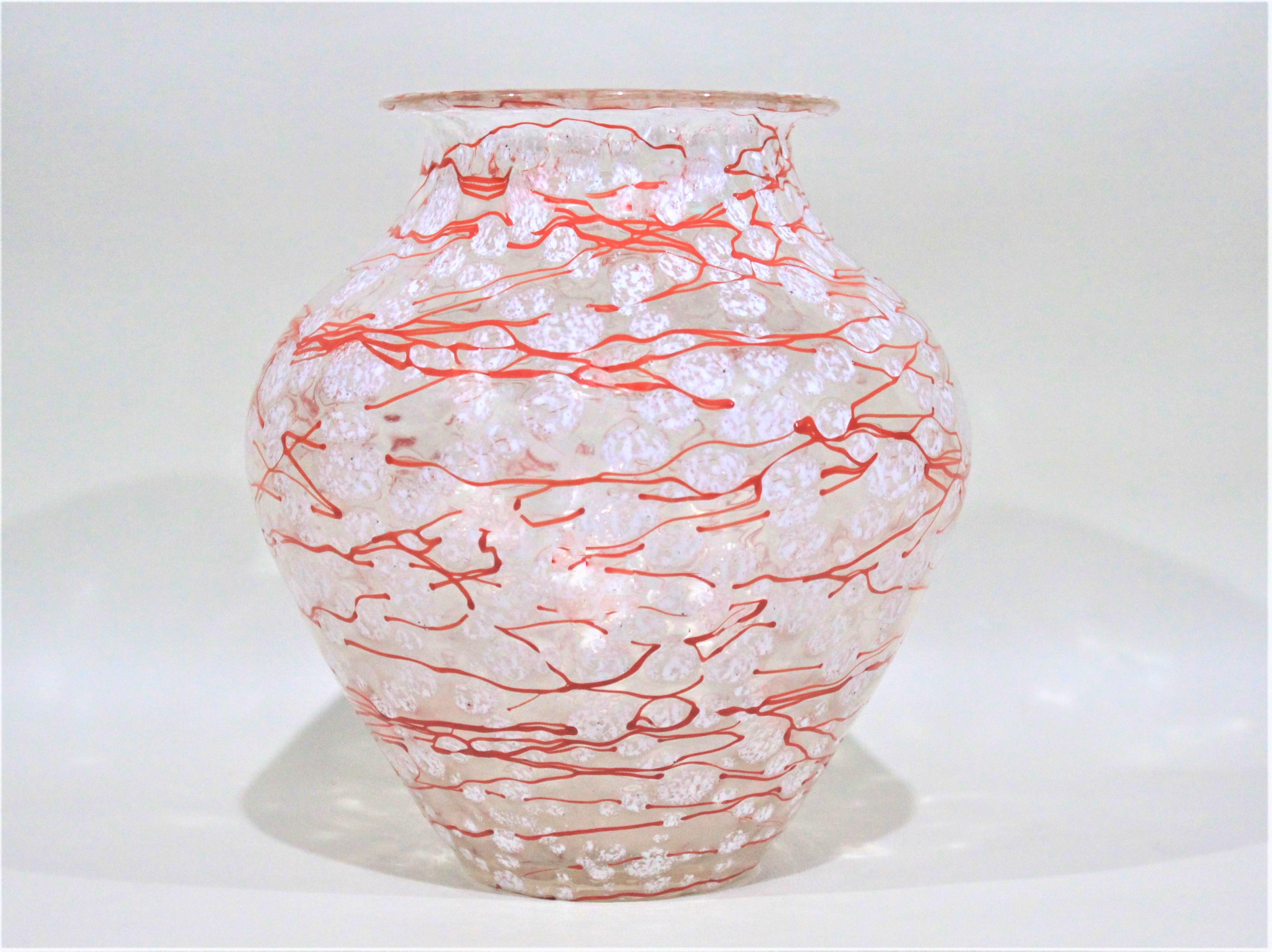 This large art glass vase by Loetz dates from the 1930s and is done by Ausfuelrung C. Schneelflocken in the pattern known as 'Snowflakes'. This vase has been executed with a series of orange fine swirls over white droplets of glass representing