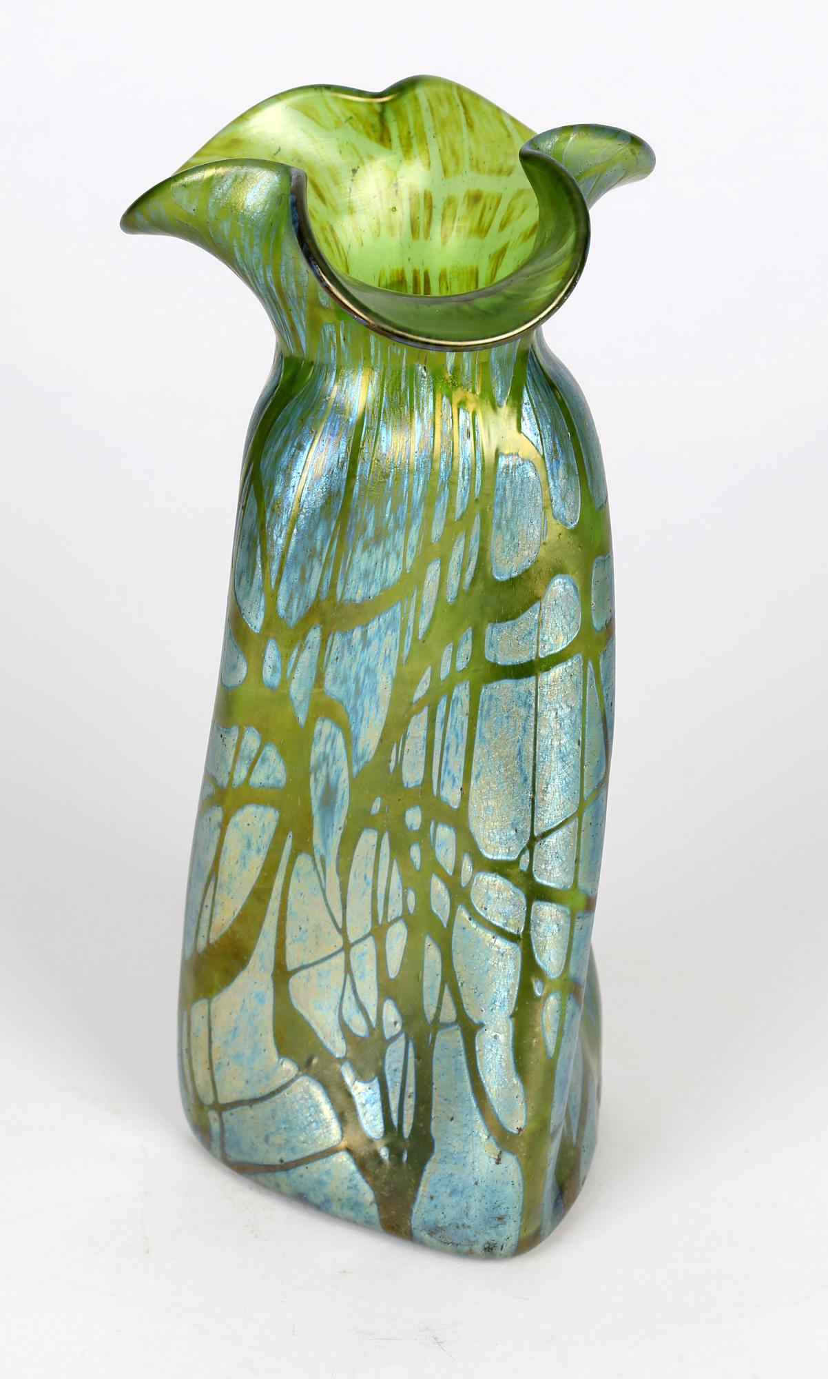 A large Austrian Art Nouveau iridescent green glass vase in abstract 'papillon' design by Loetz and dating from around 1900. The vase is of triangular shape with a spiral or propeller design narrowing to a tricorn pinched flower shaped top. The