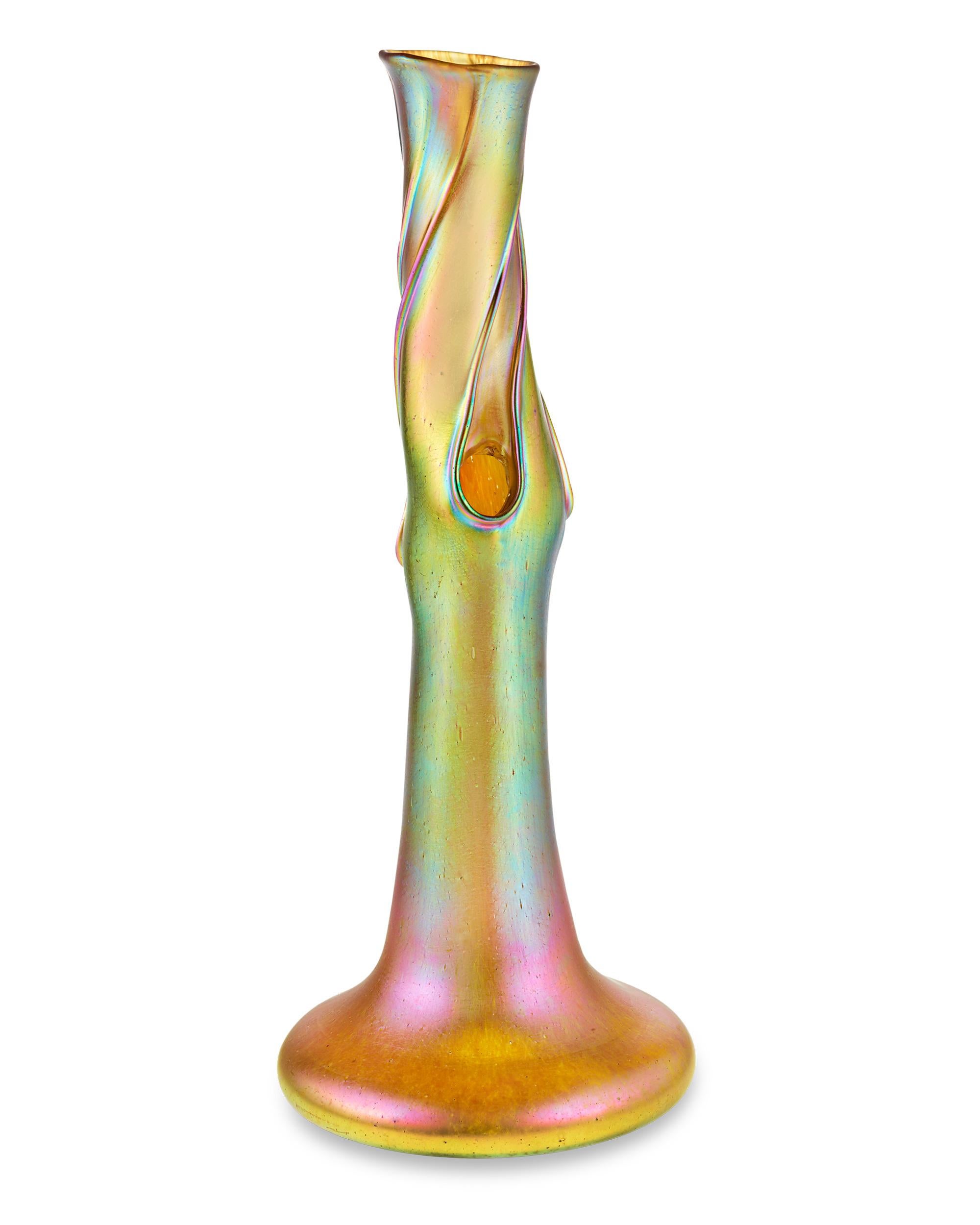 Iridescent swirls adorn this rare Candia Silberiris tree trunk vase from the renowned 19th-century art glass firm Loetz. Crafted in a sensuous, organic design with Loetz's signature luster and measuring over 16 inches in height, this vase exhibits