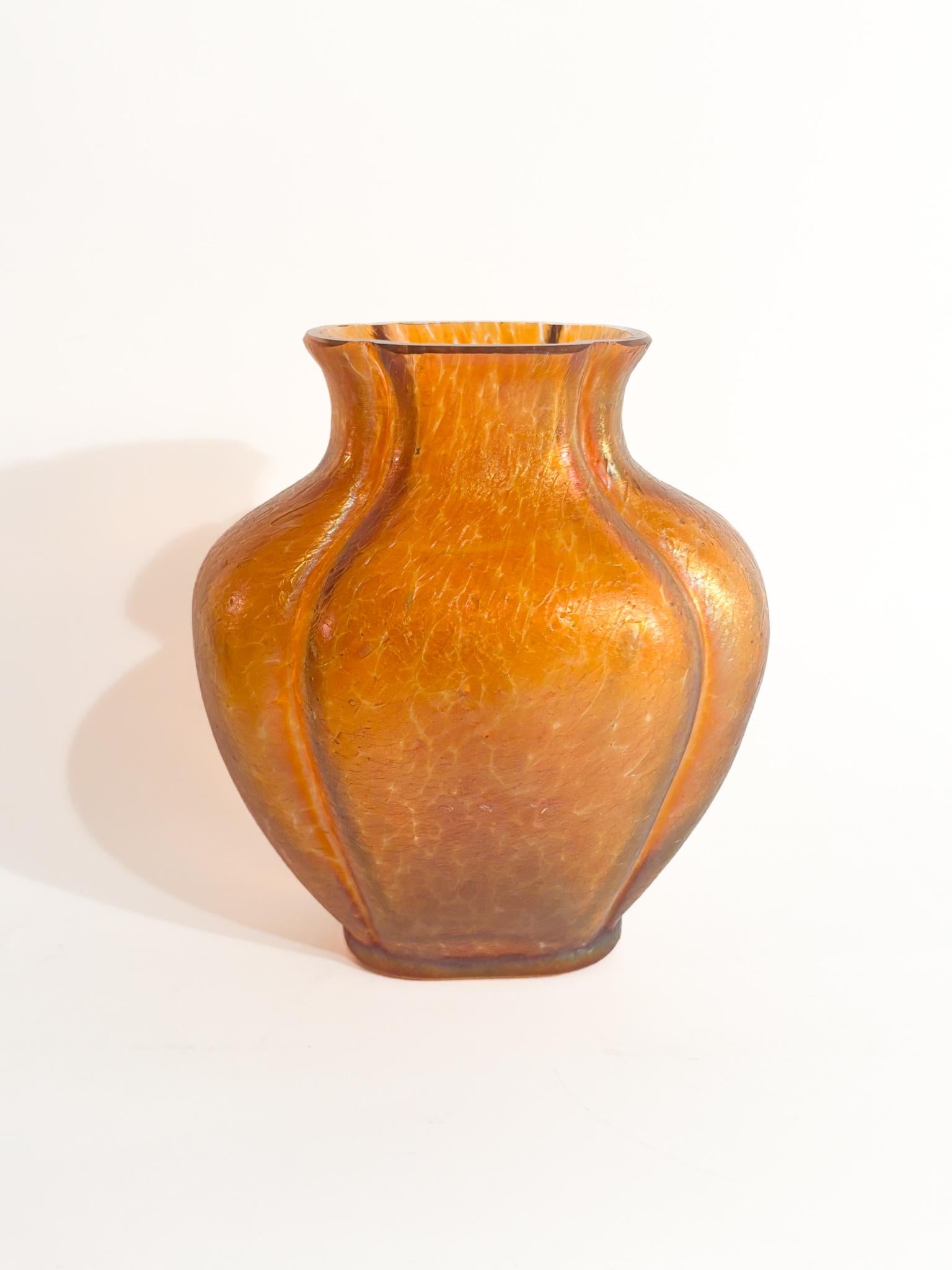 Iridescent orange and pink glass vase by Loetz, made in the 1950s.

Ø cm 10 h cm 11

Loetz is a name that immediately evokes images of extraordinarily beautiful and refined blown glass. This Austrian glassworks, founded in 1839, produced some of the
