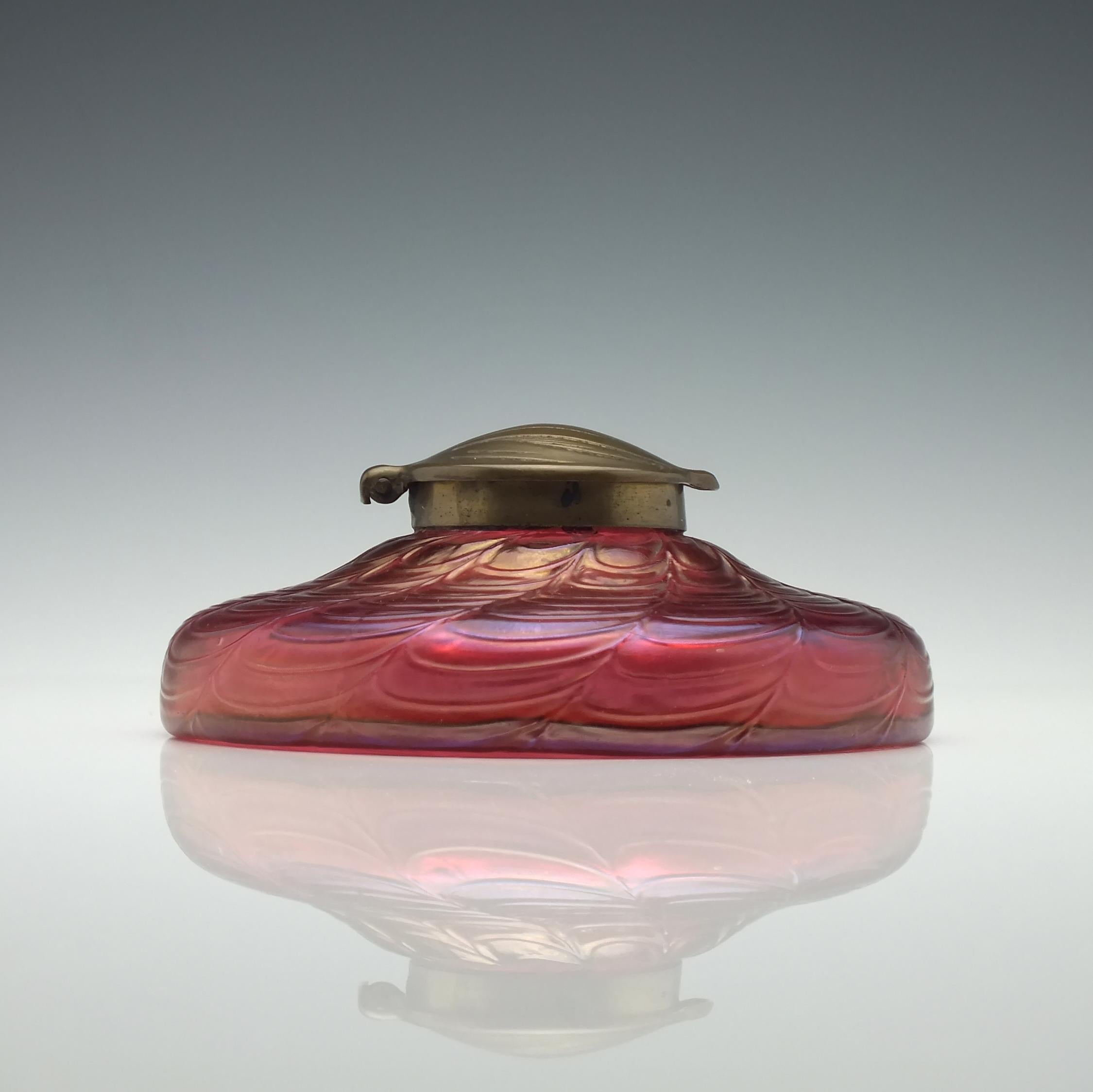 Date and origin 

Klostermühle, Bohemia, circa 1910.

Condition

Excellent, age-related wear as shown. 

Dimensions 

Height 5.7cm, diameter 13.3cm

Weight

455 grams

Technical Description 

A Loetz glass inkwell. A short body