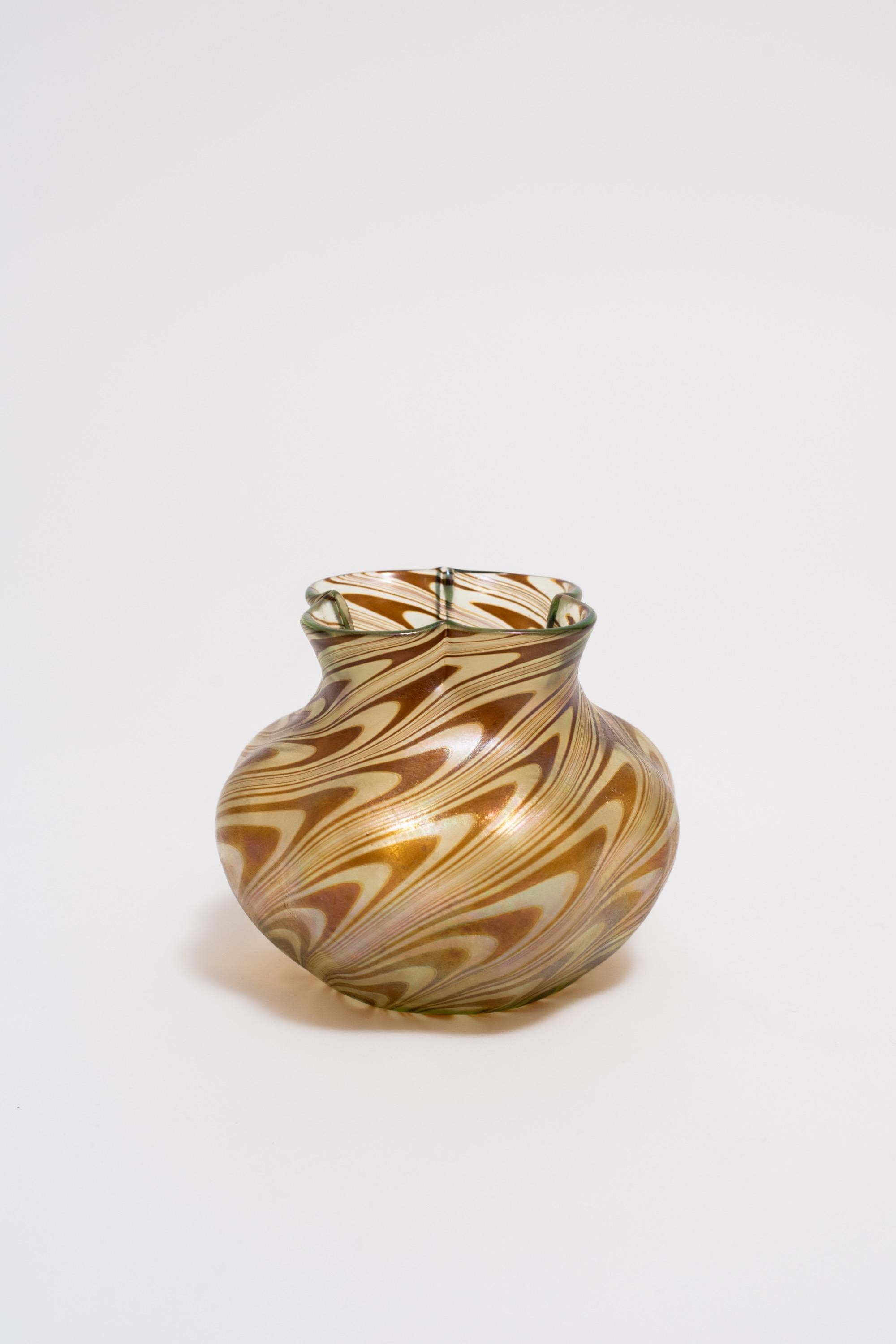 A glass vase by Loetz, the premier art glass producer of the Art Nouveau period in Bohemia (present day Czech Republic). This vase is an example of the Phanomen genre of glass decor, defined by colorful, organic forms spiraling upwards. In this