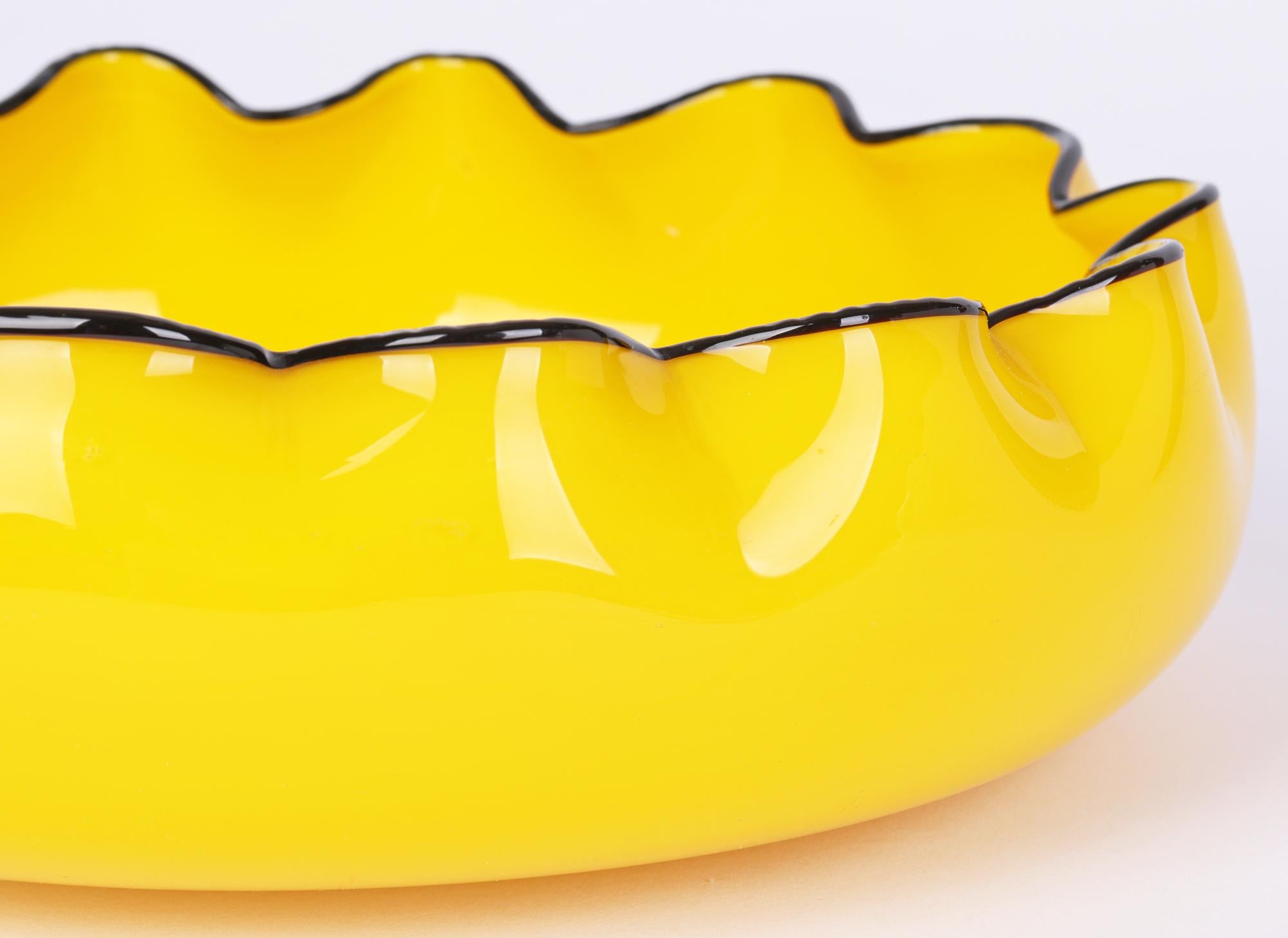 A striking and large Loetz yellow art glass hand-blown bowl piped with a black glass rim by renowned Austrian Sculptor, Ceramist and Designer Michael Powolny (Austrian, 1871-1954) dating from around 1916. 

Michael Powolny produced a number of