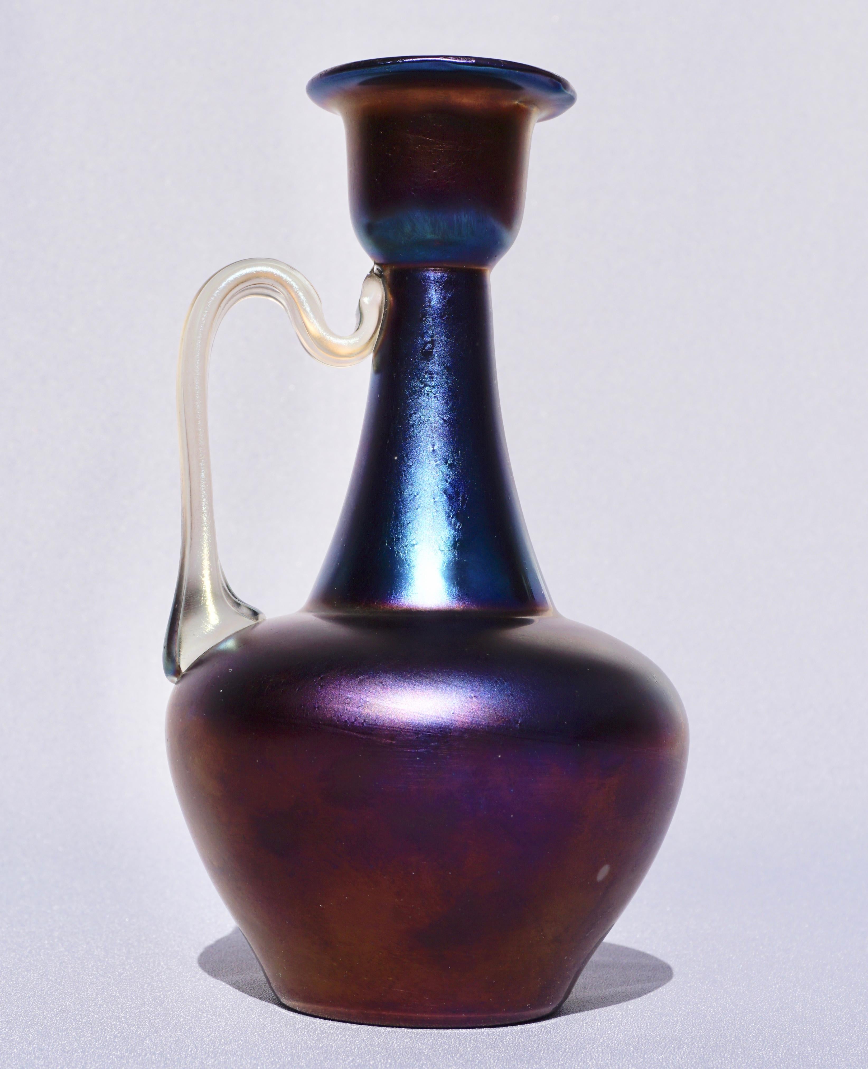 Loetz Rubin Matte Iris - 1898 (aka: rubin metall)
Registered Model: PM I-7875

Ruby ground; metallic-bronze iridescent finish (iris) with purple highlights.

Measures: Height 7.75 inches
Width 4.25 inches

Condition: Excellent

AVANTIQUES is